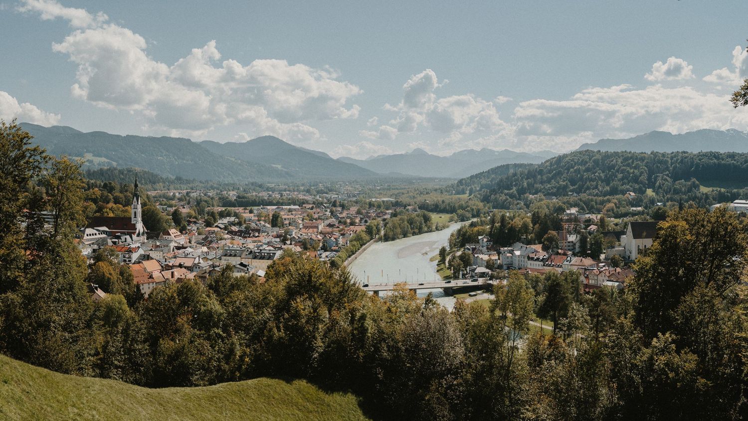 Panoramic mountain landscape view with city nestled in valley below.