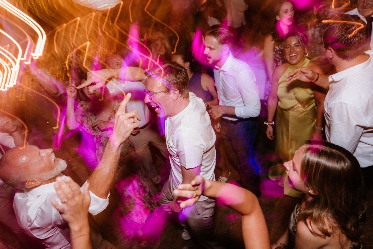 Festive dance party with colorful lighting and motion blur effects.