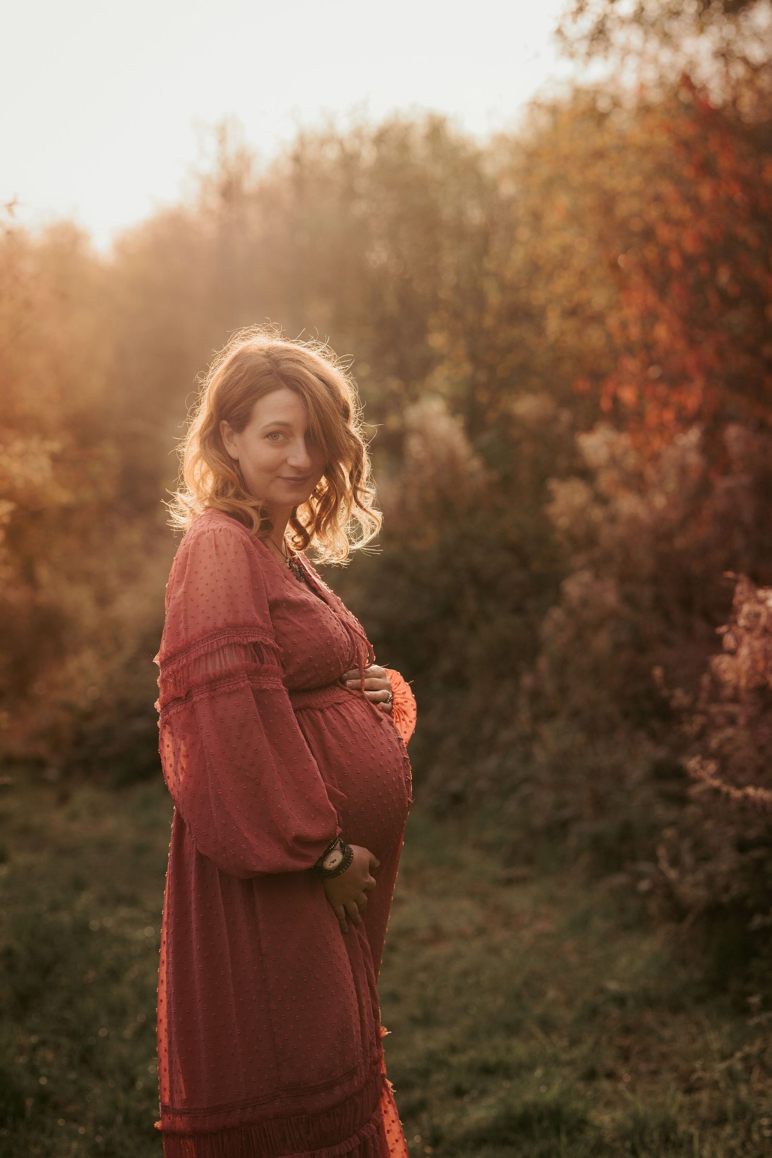 Expectant mother holding her bump during a maternity photoshoot
