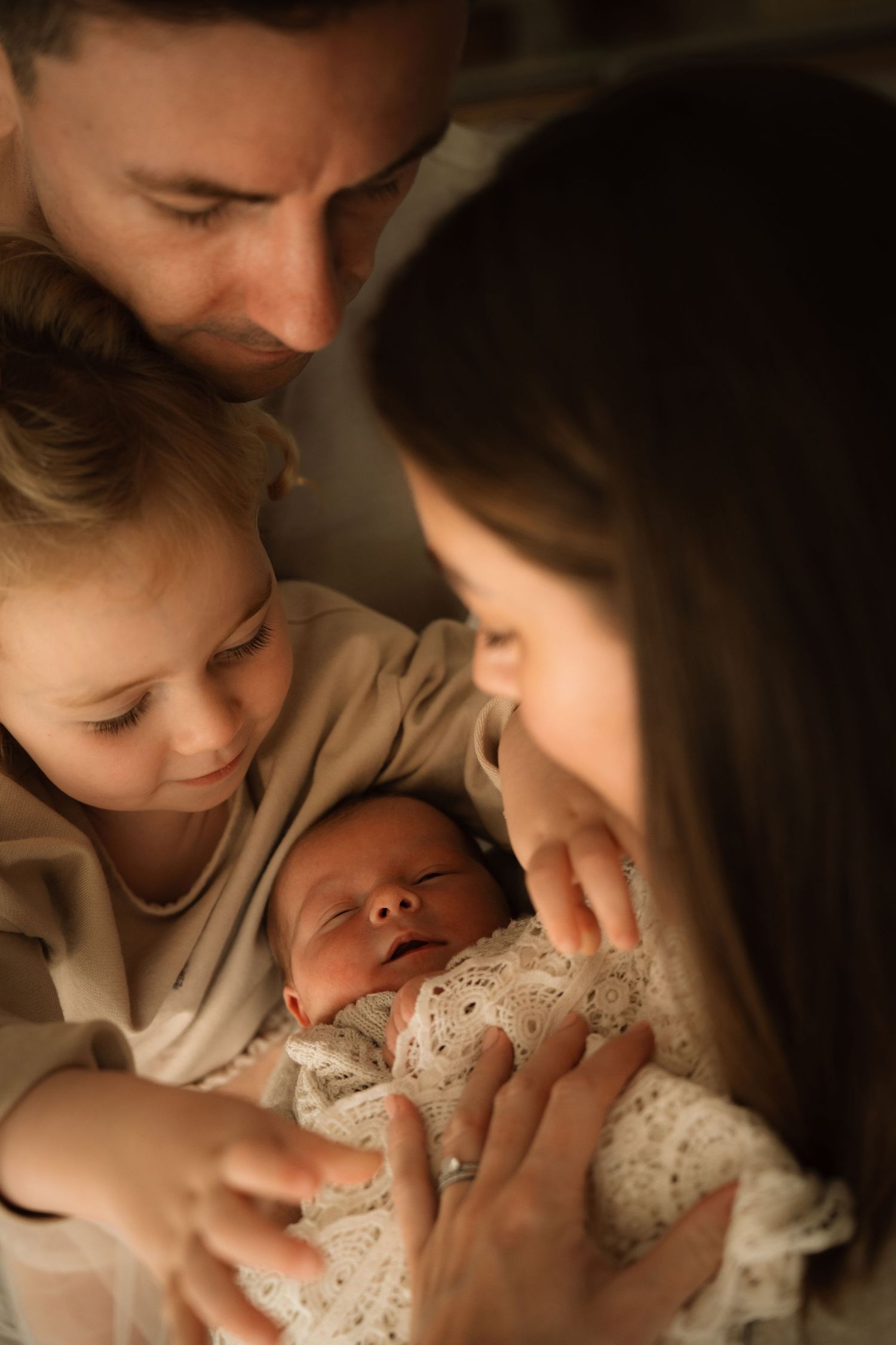 Intimate family moment during newborn photoshoto with soft stories by angela in Swadlincote