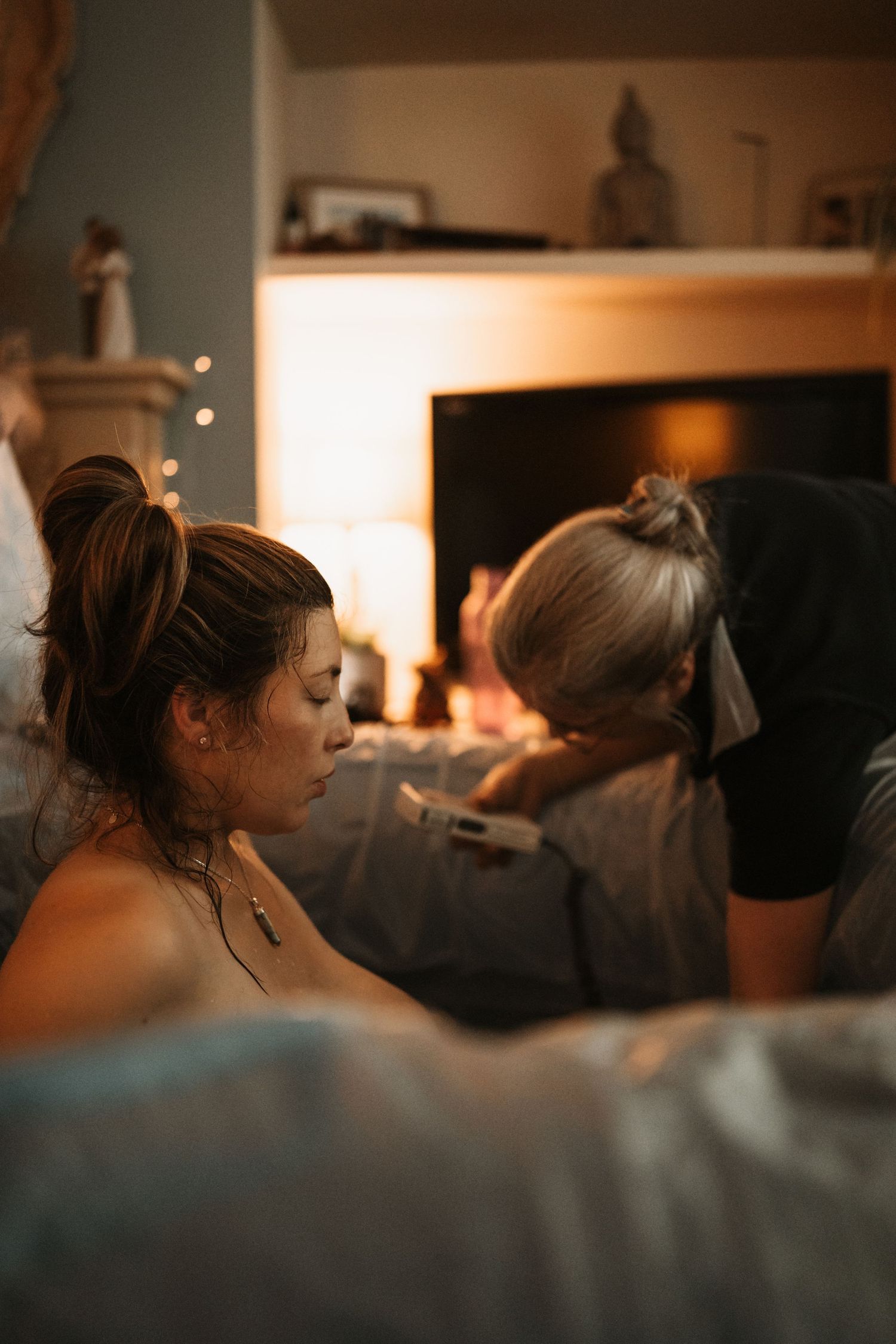 Birthing parent resting between contractions at home during a documentary birth photoshoot.