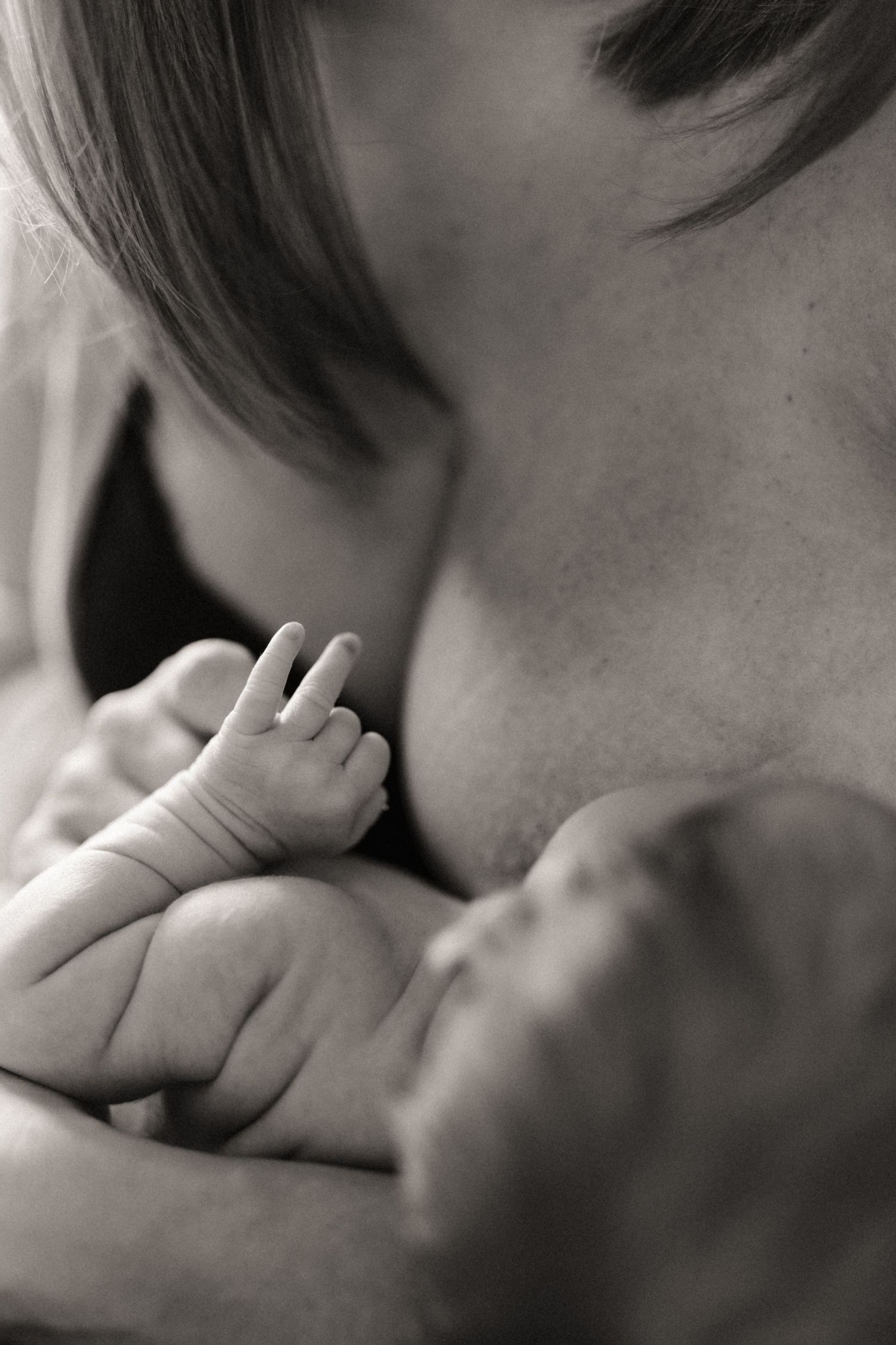 Close-up of a newborn resting against a parent during a quiet lifestyle newborn photoshoot in Tamworth