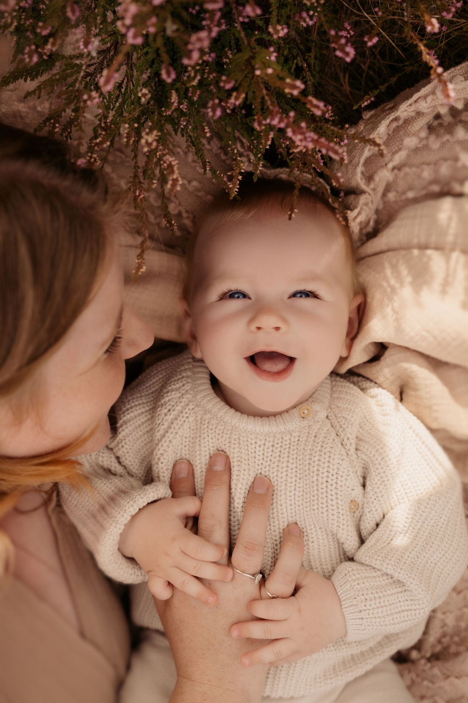 Playful cuddle between mum and baby under soft autumn light – Swadlincote family photographer.