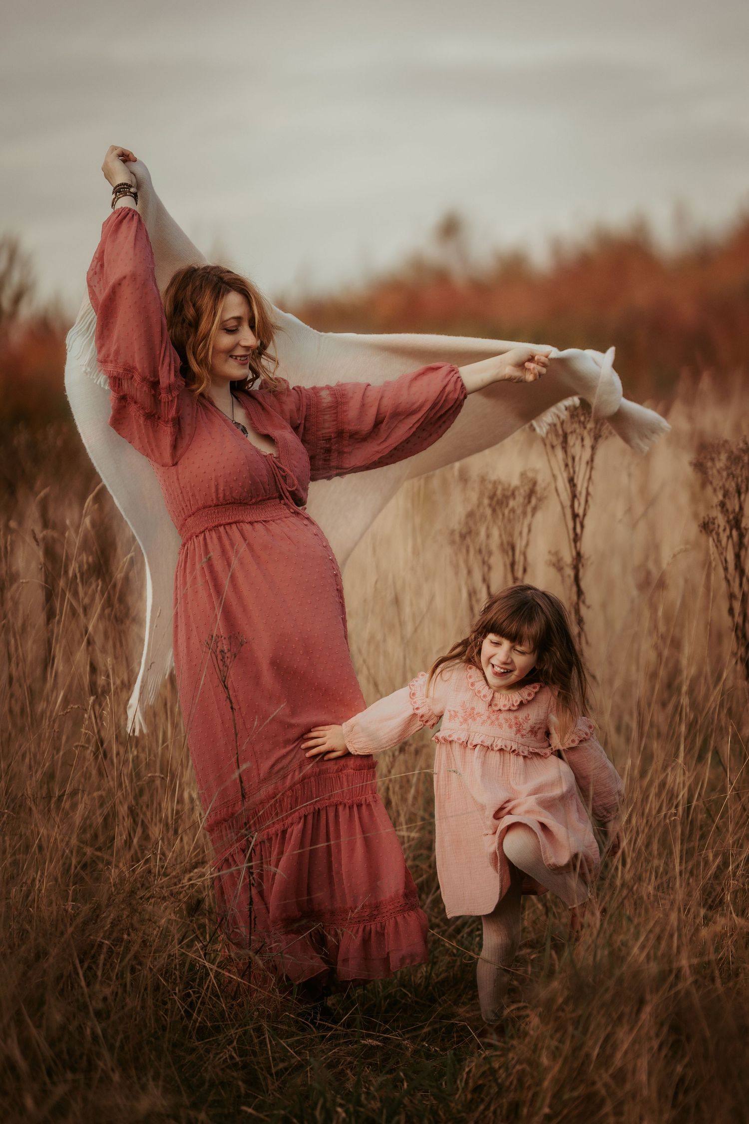 Parent and child walking in a field, playing together during a family session in Ashby