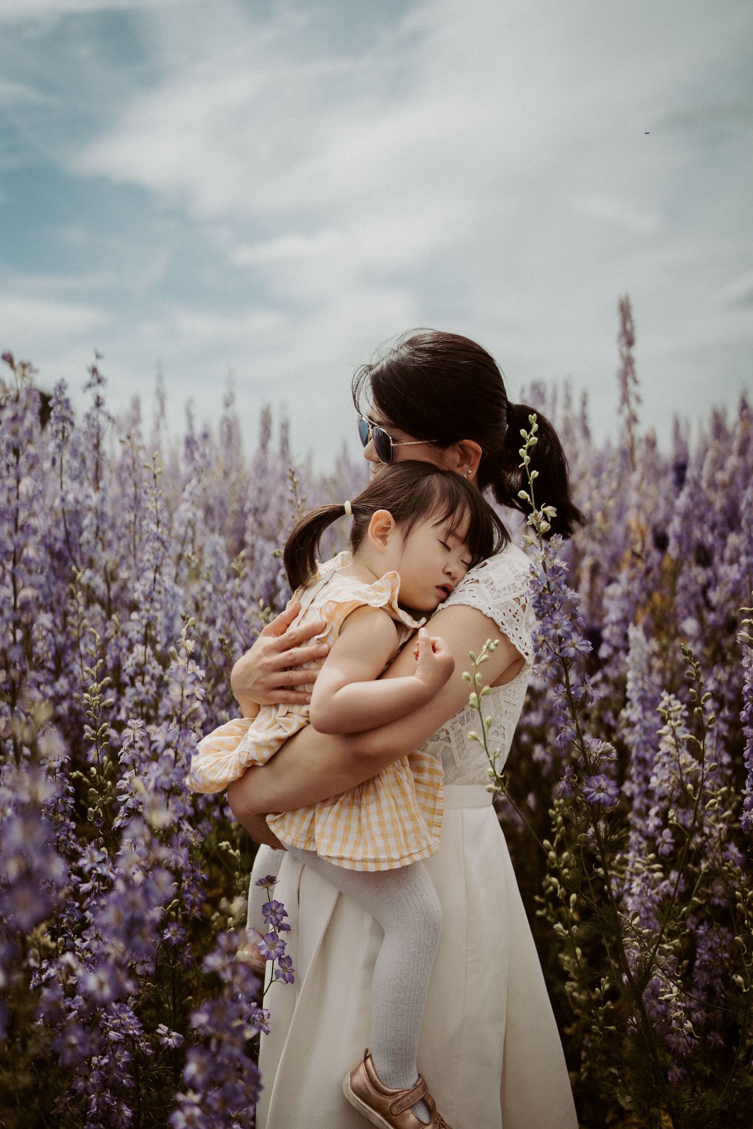 Mum with a sleeping baby in the flower field — Soft Stories by Angela