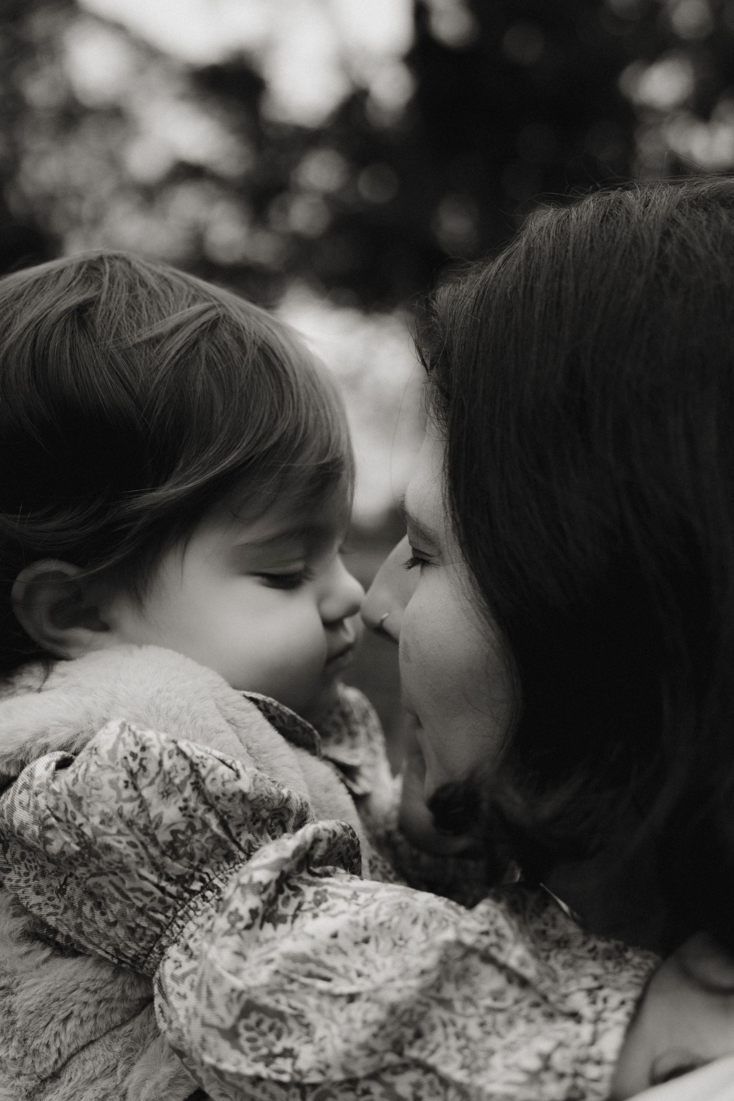 A black & white close up of mum and her one-year-old during birthday shoot, touching their noses