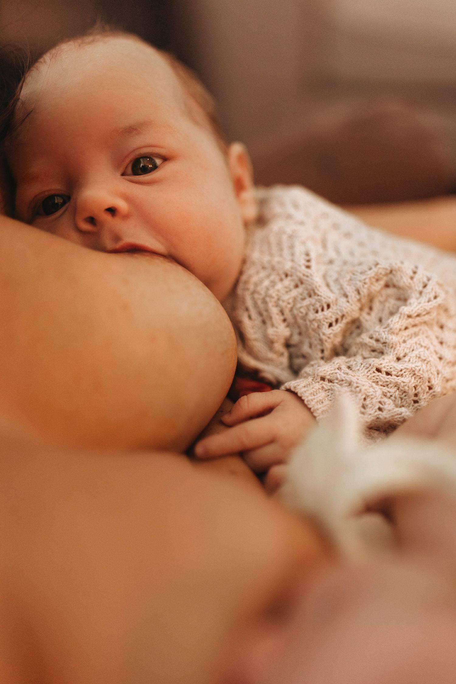 Close-up of a newborn being brestfeed, captured naturally during a storytelling newborn photoshoot in Leicester