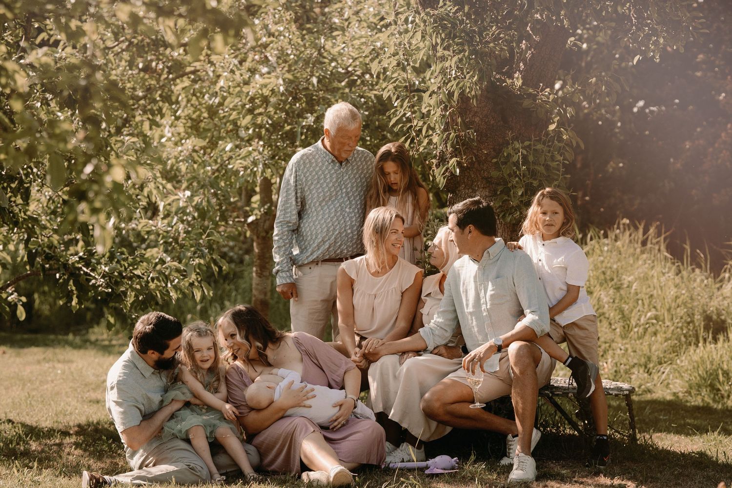 Extended family gathers outdoors in sunlight during a joyful multigenerational photoshoot in Tamworth