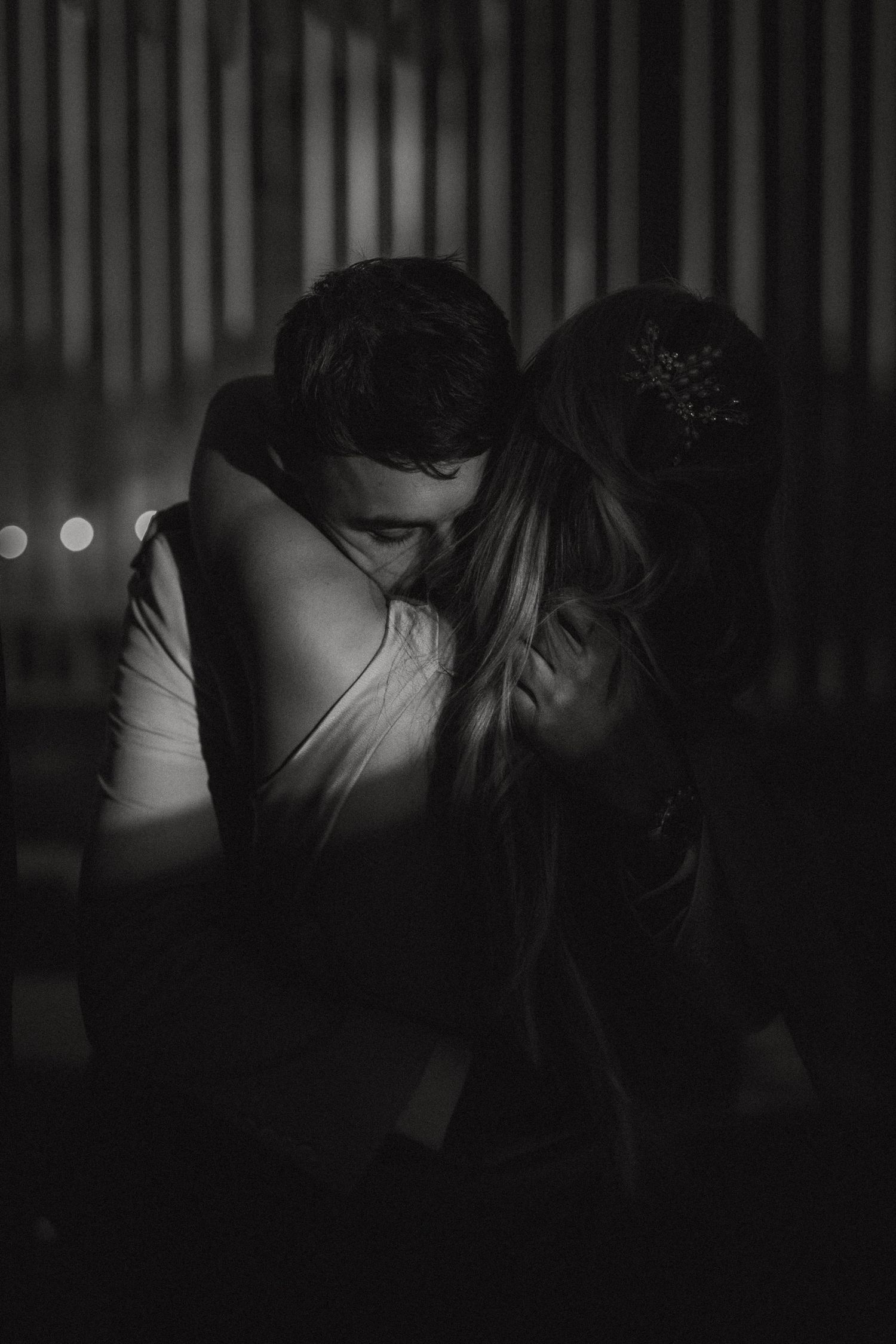 Couple embraces in soft evening light during an intimate and emotional storytelling photoshoot.