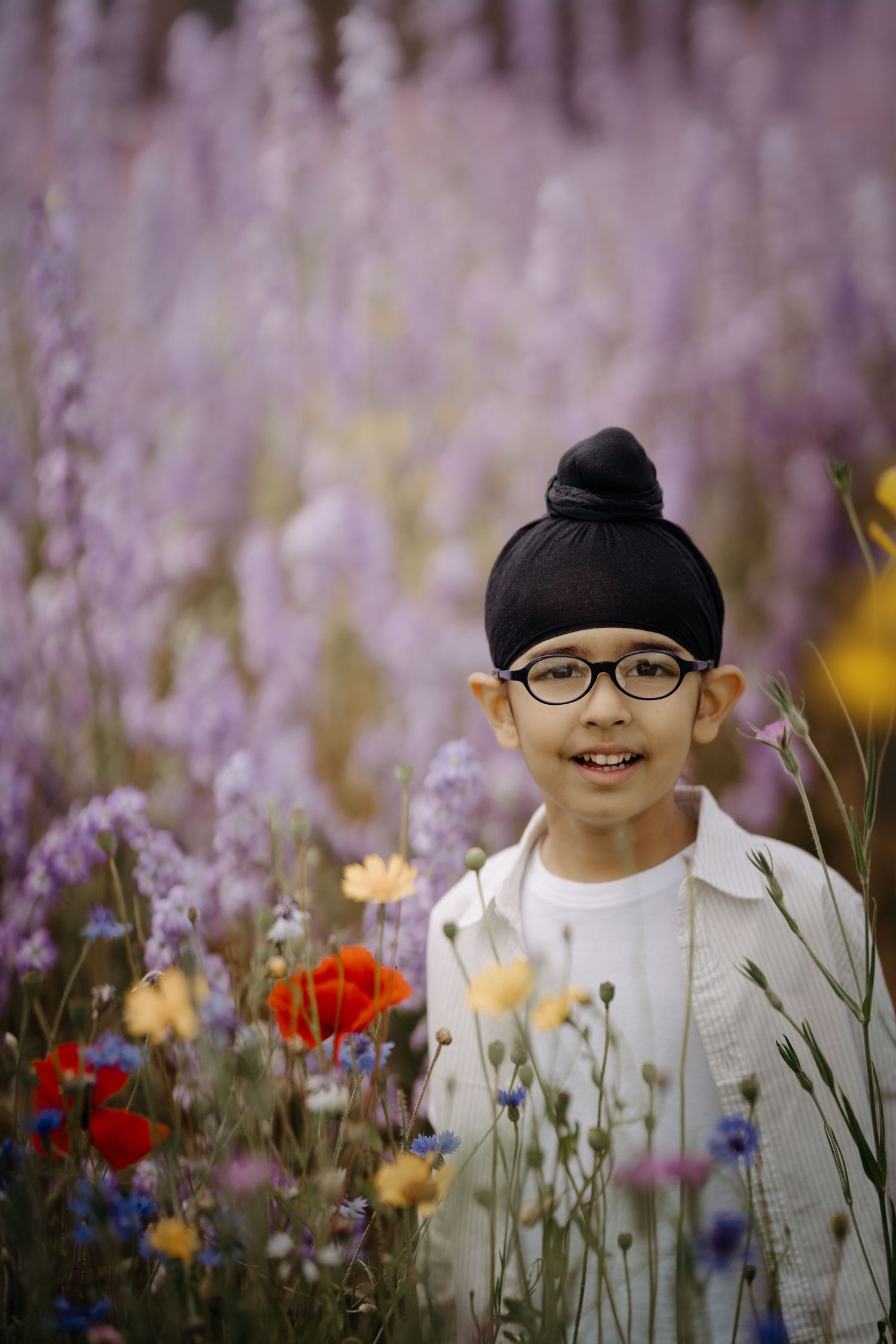 Family session at The Real Flower Petal Confetti Field - a boy in the delphinium field