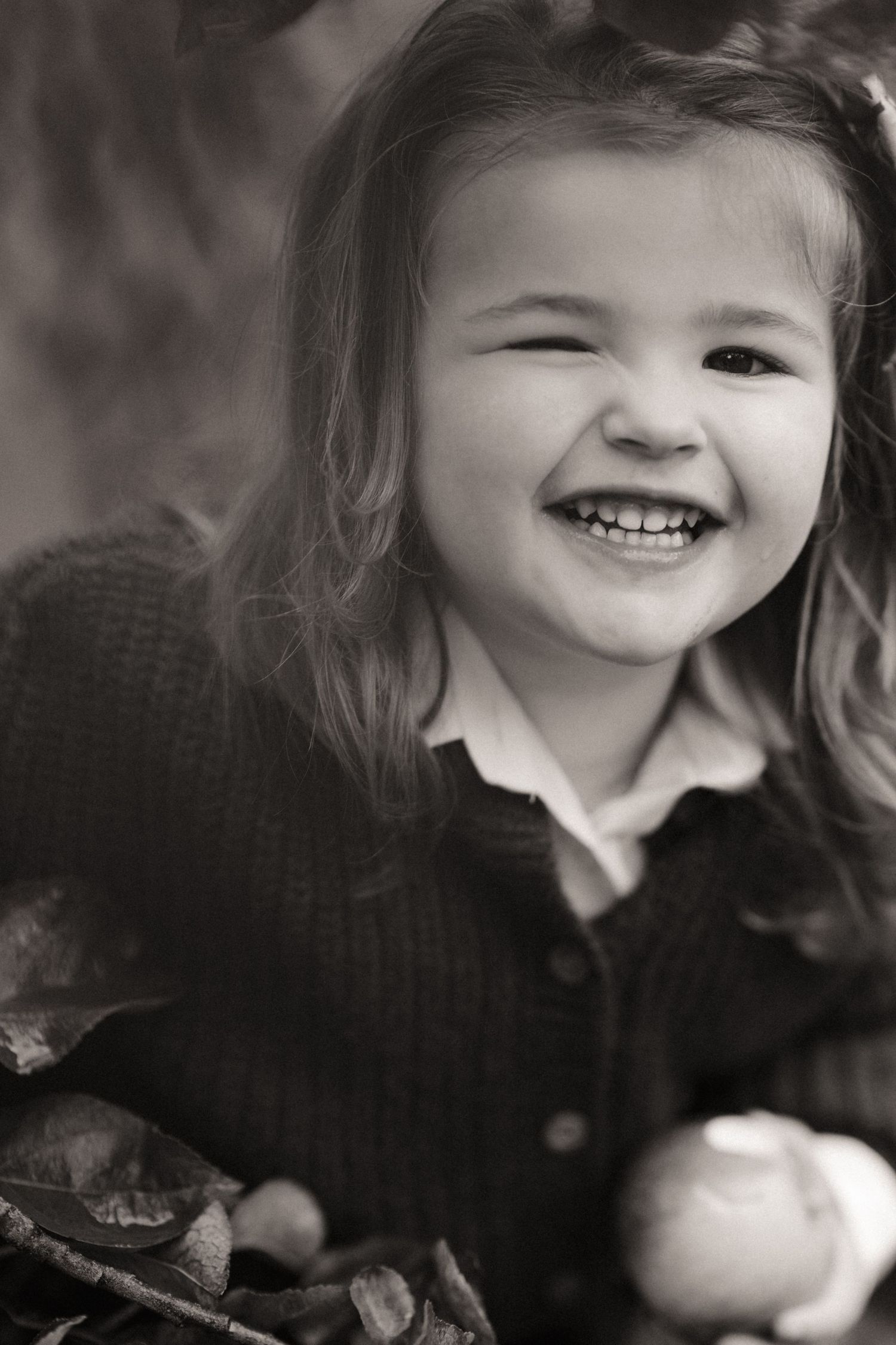 Smiling girl looks up with joy during a natural lifestyle portrait by Alalas Photography in Lichfield.