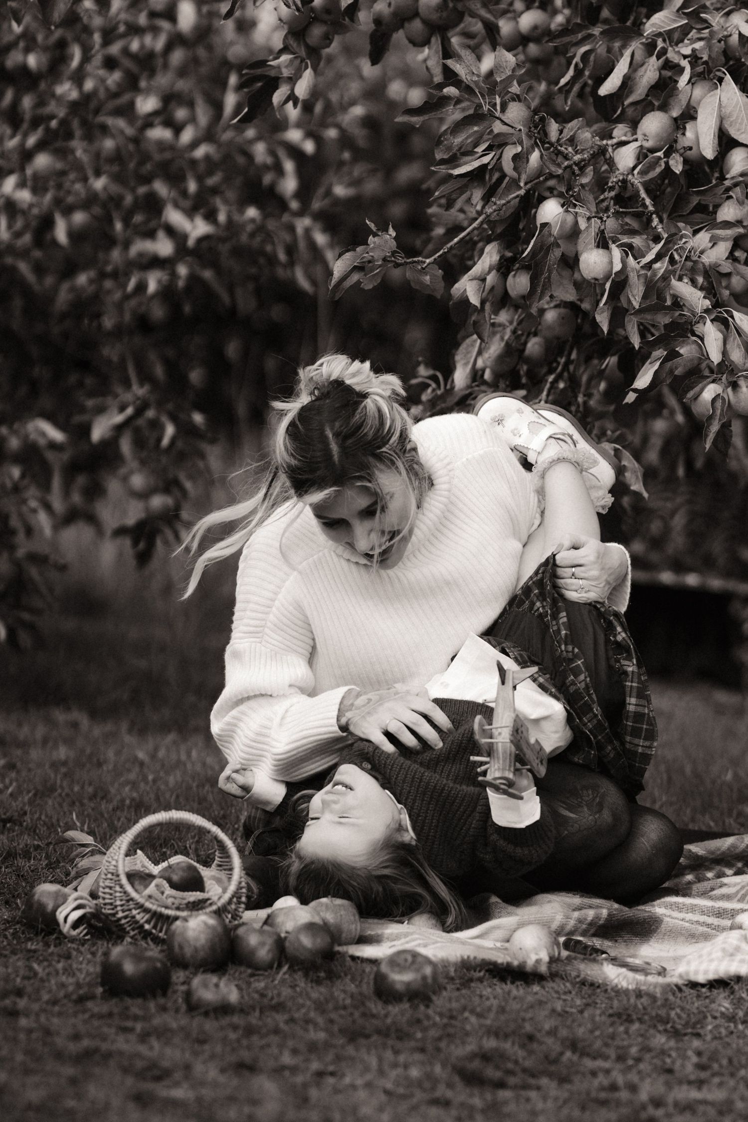 An intimate family moment between mum and daughter during apple orchard photoshoot in Tamworth