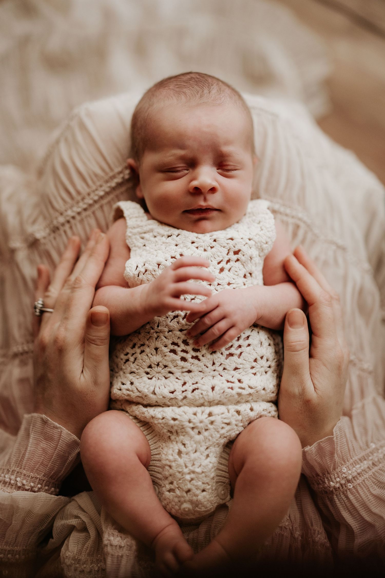 Newborn resting peacefully on a soft blanket, photographed simply and honestly during a calm lifestyle newborn photoshoot with Soft Stories