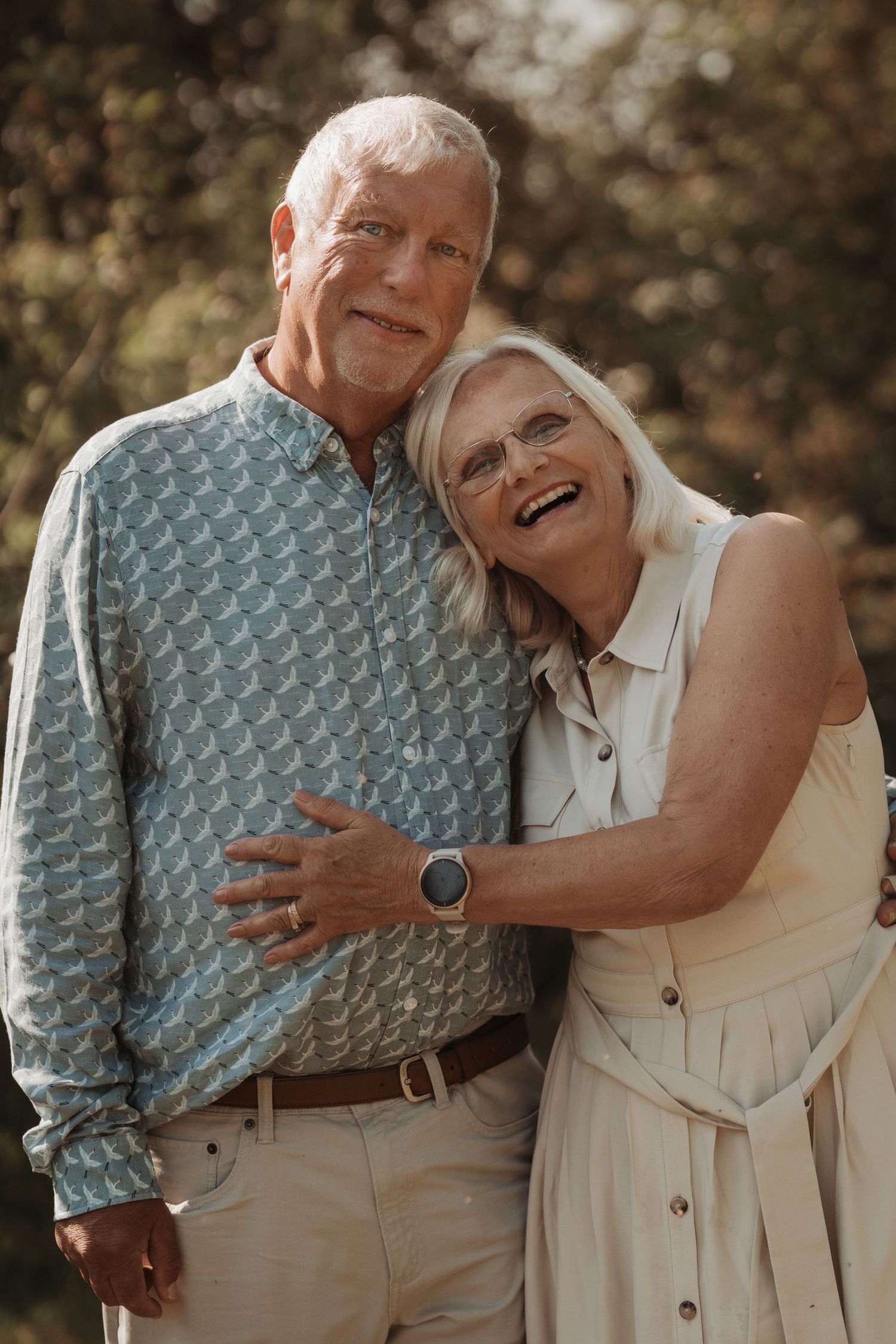 Elderly couple embraces in golden light during a warm outdoor family photoshoot in the Midlands, Tamworth