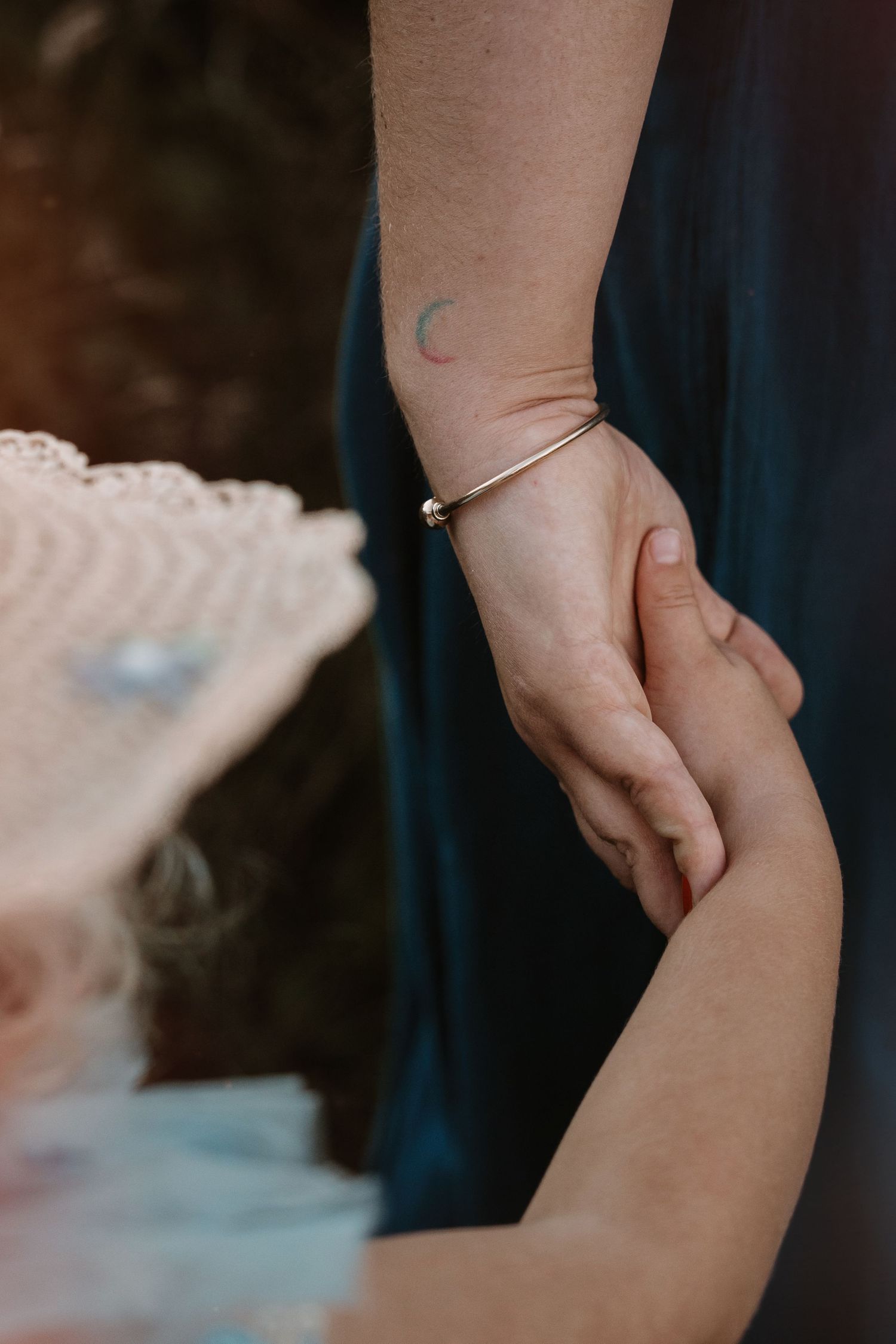 Tiny hand held in a mother’s gentle grasp – tender storytelling captured by Swadlincote family photographer.