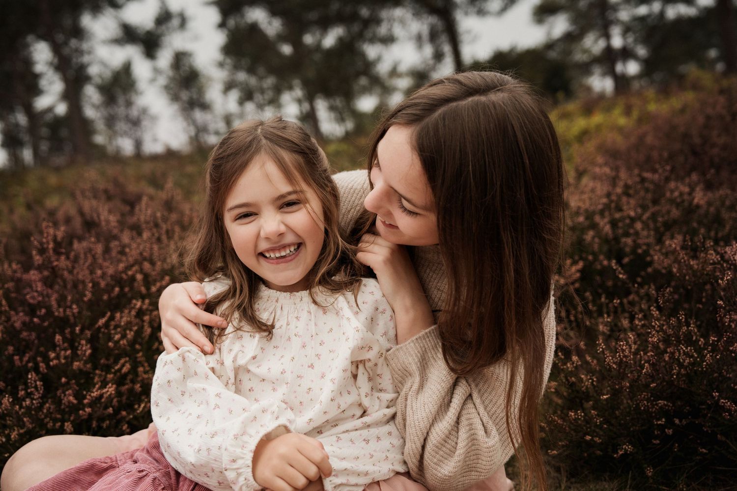 Sisters share laughter outdoors during a heartfelt family photoshoot in the Midlands, BIrmingam Lickey Hills