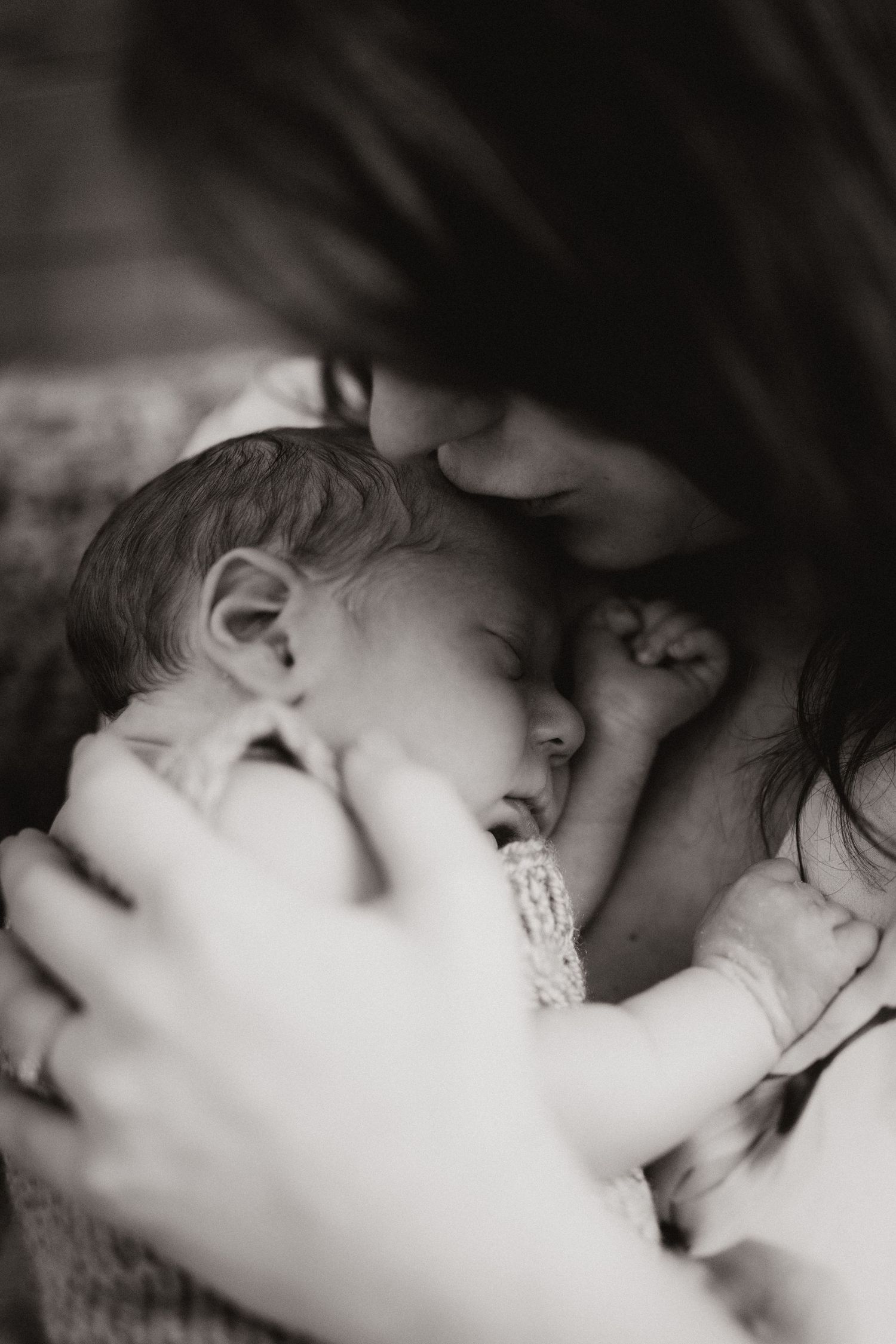 An intimate family moment between mum and baby during a newborn photoshoot