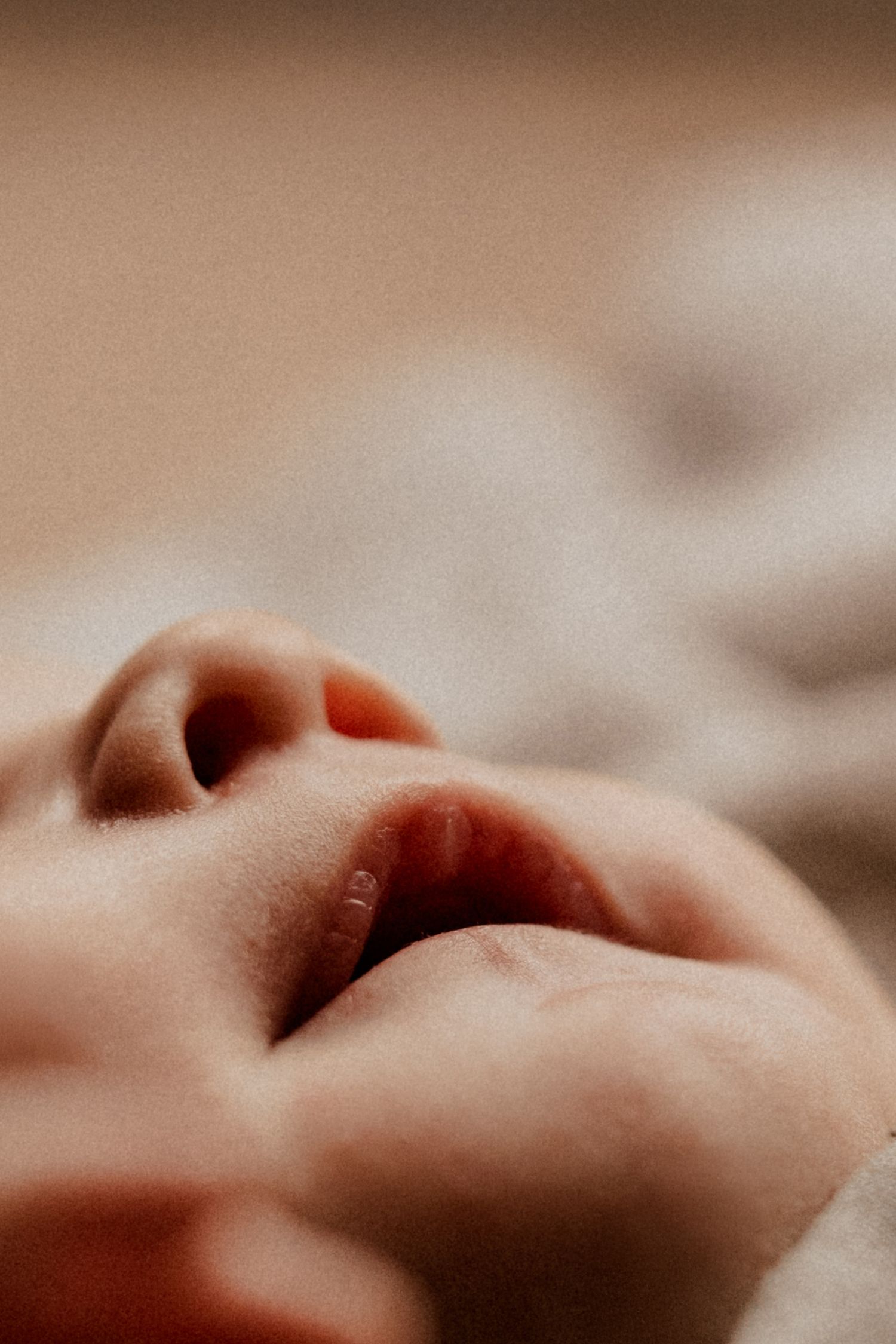 Close-up of a newborn’s lips during a soft natural-light documentary newborn photography session in East Midlands