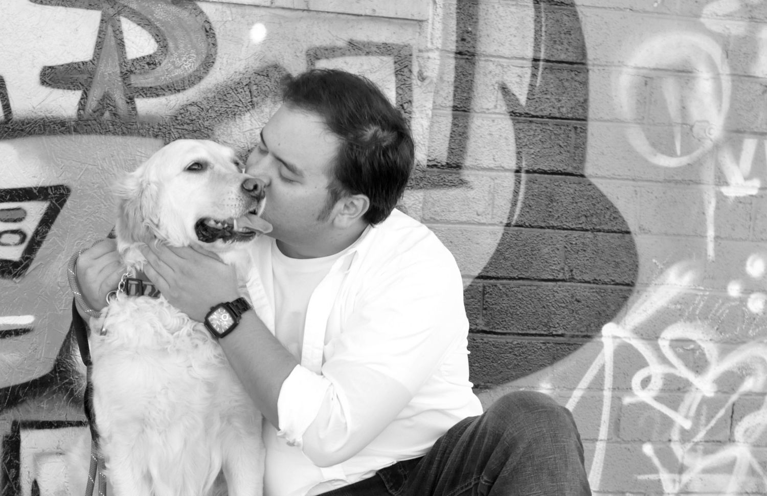 Black and white pet photography of golden retriever and owner