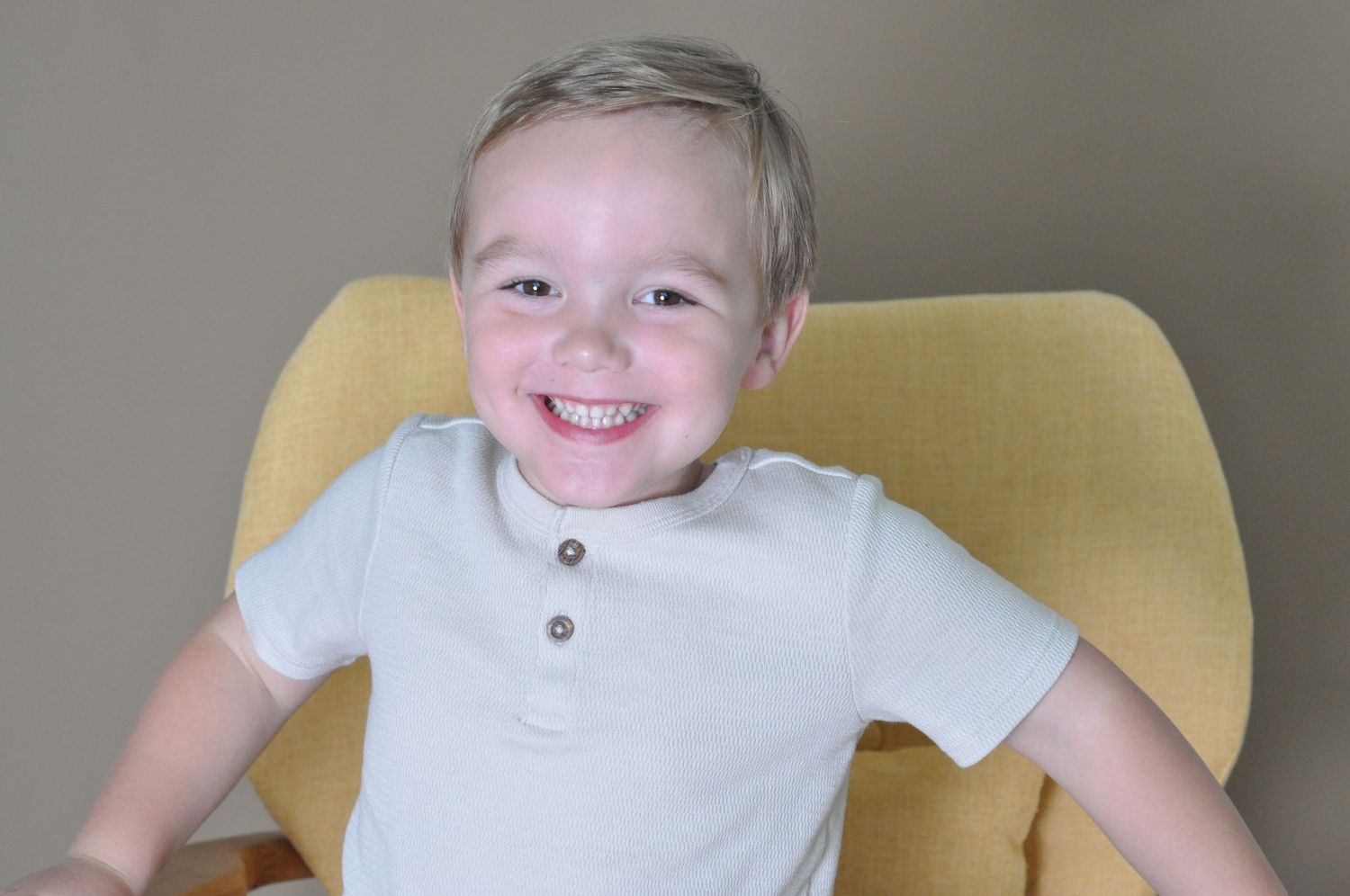 portrait children's photography boy in yellow chair posing in-studio