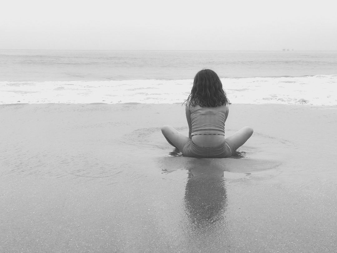 Black and white portrait of a girl looking at the ocean.  Children's photography