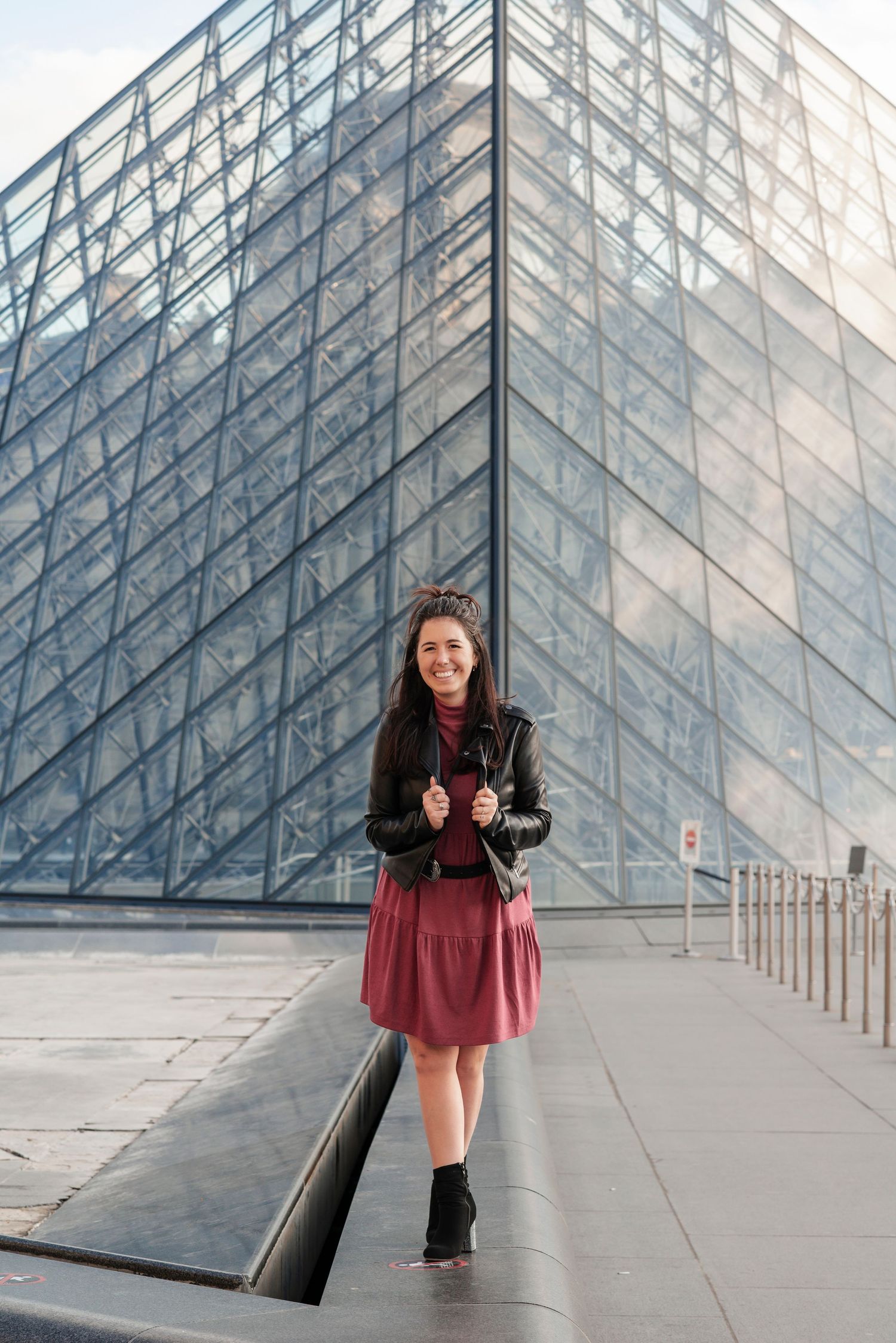 Dynamic photo series at the Louvre pyramid showing architectural lines and perspective.