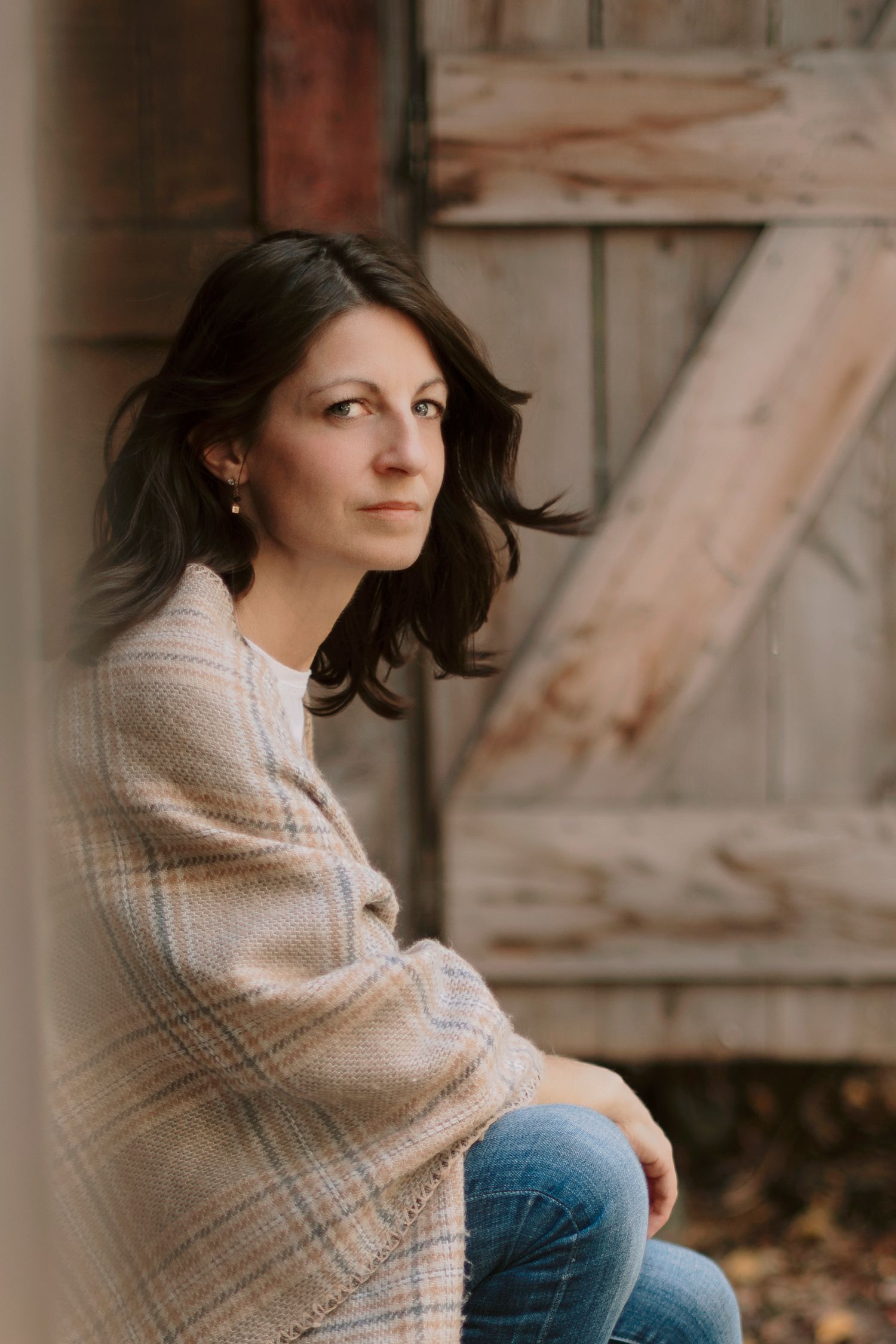 Lifestyle portraits featuring cozy sweater and casual denim against wooden backdrop.