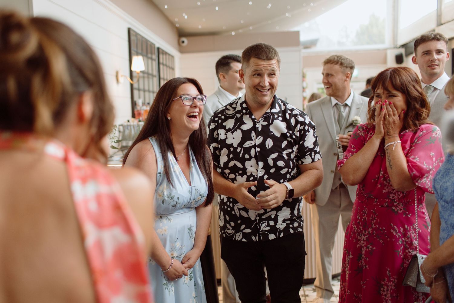 Magician Adam Reeves surprising wedding guests and making them laugh in the marquee at The New County House Hotel in Cardiff.