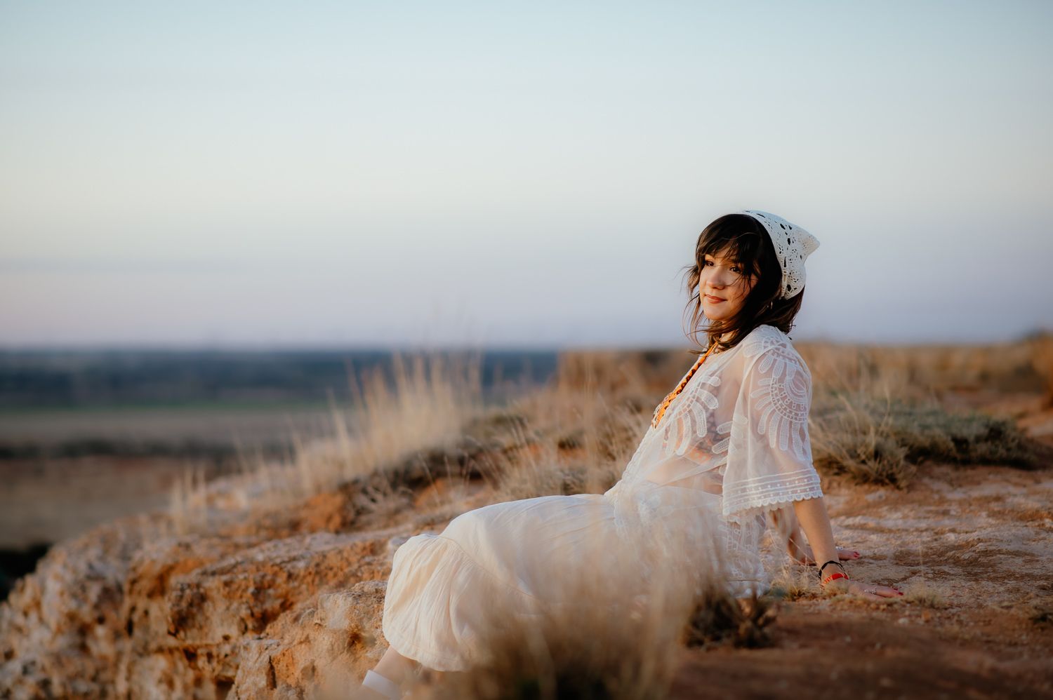 Senior girl sitting at the Gloss Mountain near Enid OK.