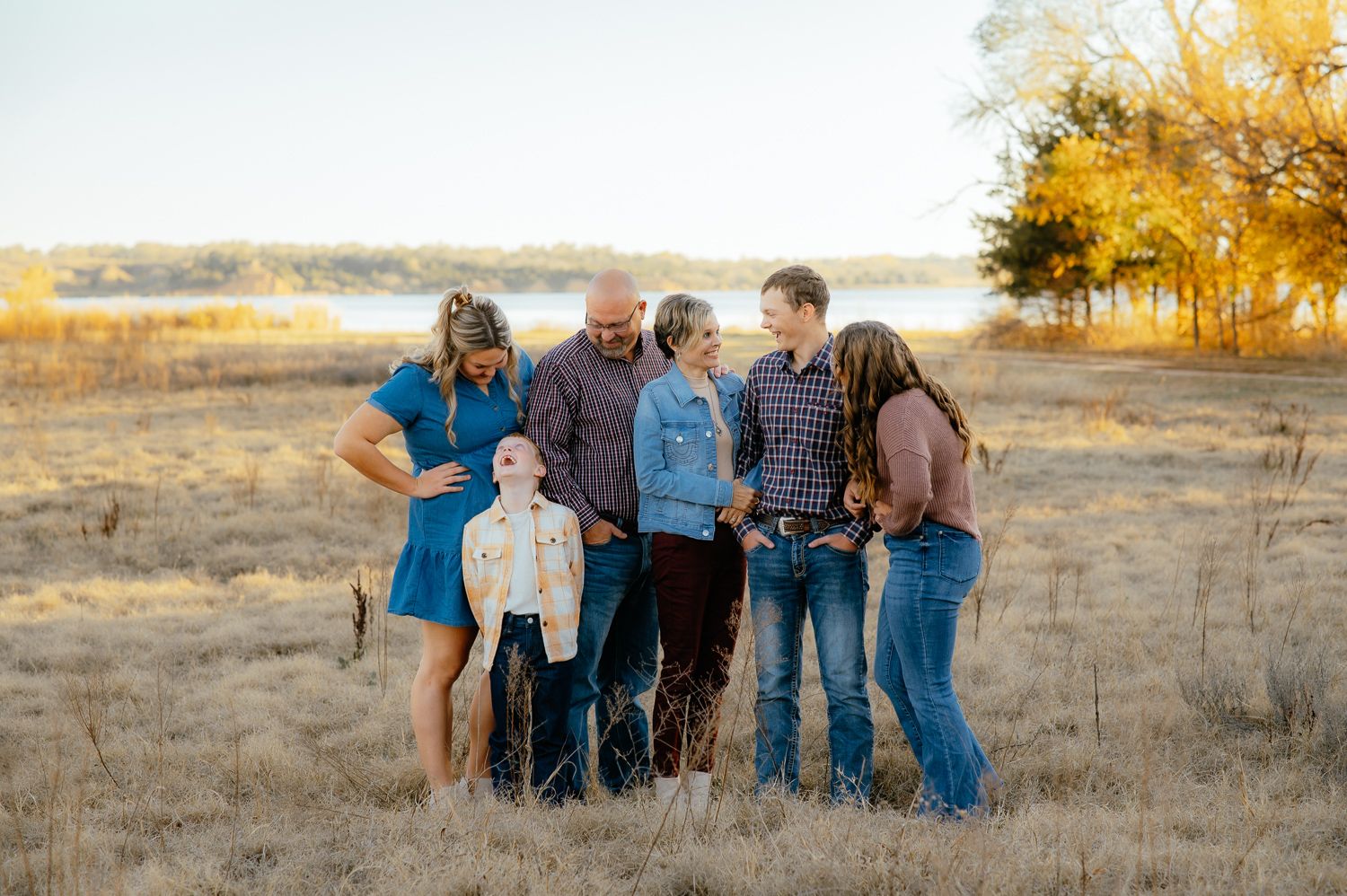 Family of six smiling for family photos with Taryn Elizabeth an Enid Family Photographer.