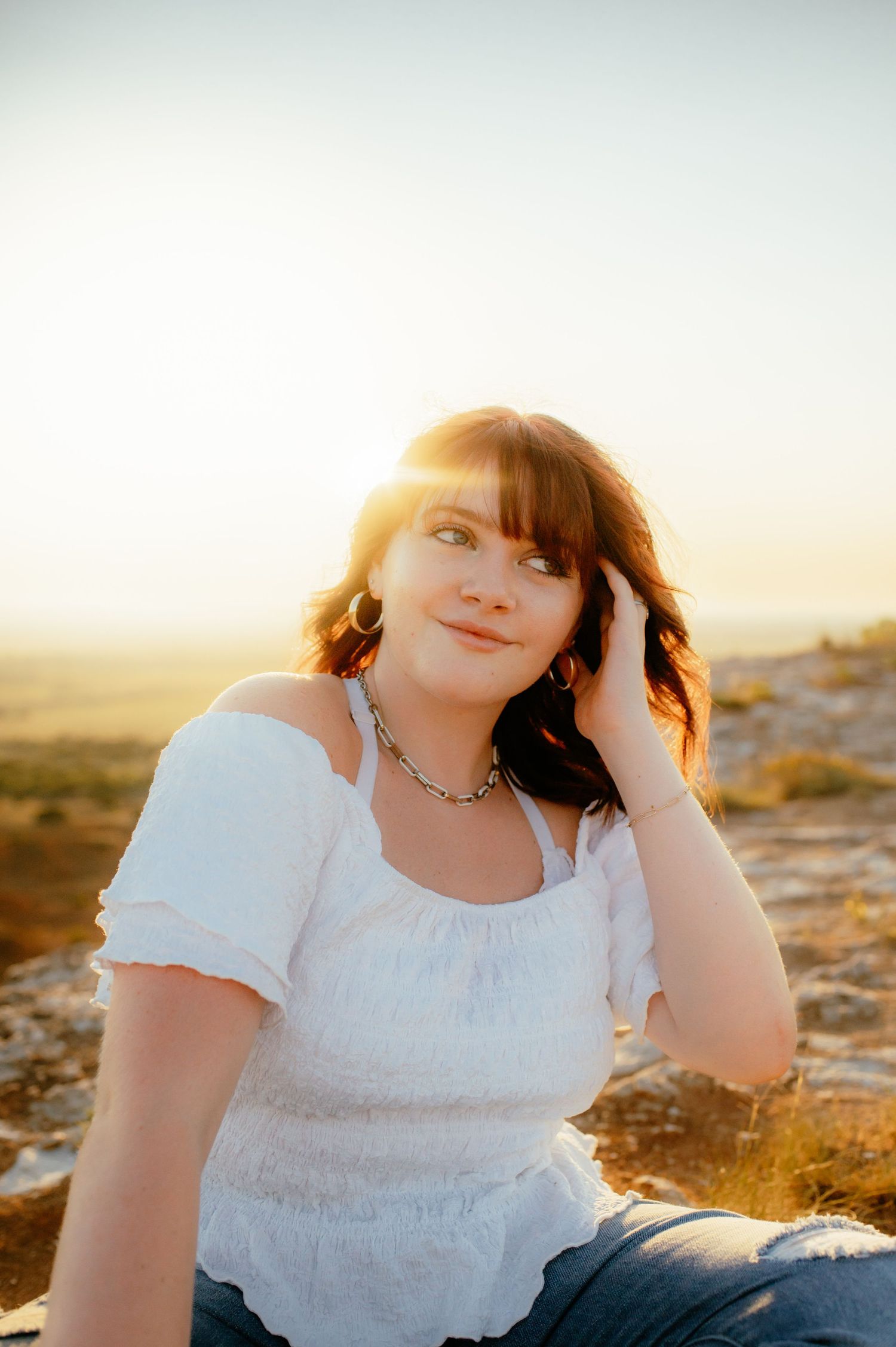 Fairview Oklahoma senior girl posing for a photo at the top of the Gloss Mountain, with Enid OK Photographer.