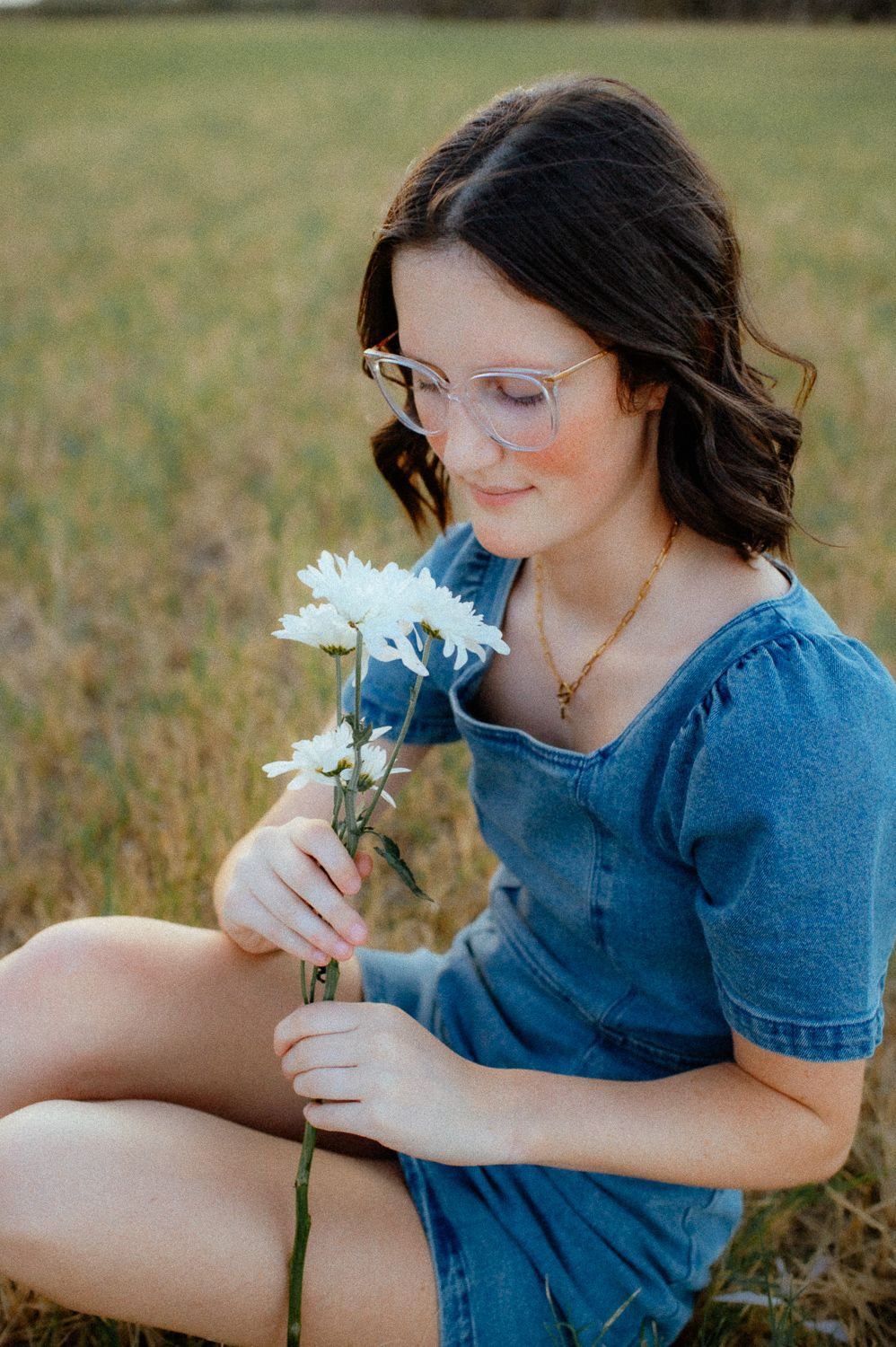 Senior girl setting down during her Enid senior portraits.
