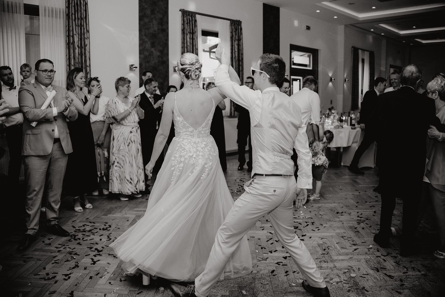 A sequence of black and white wedding reception photos showing dancing and celebration on the dance floor.