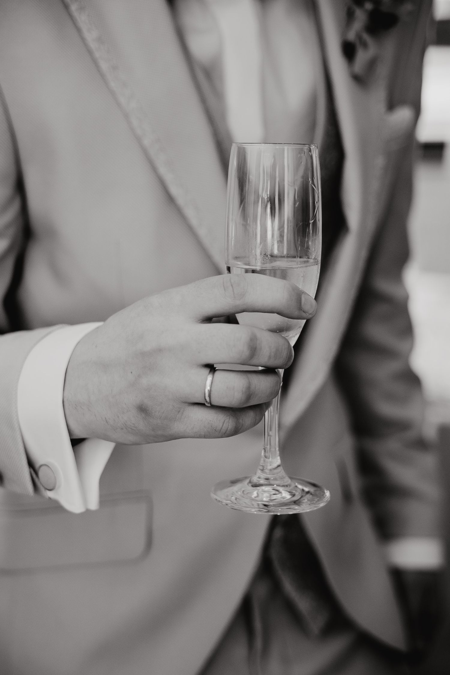 Black and white photo series showing hands holding champagne glasses at an elegant event.