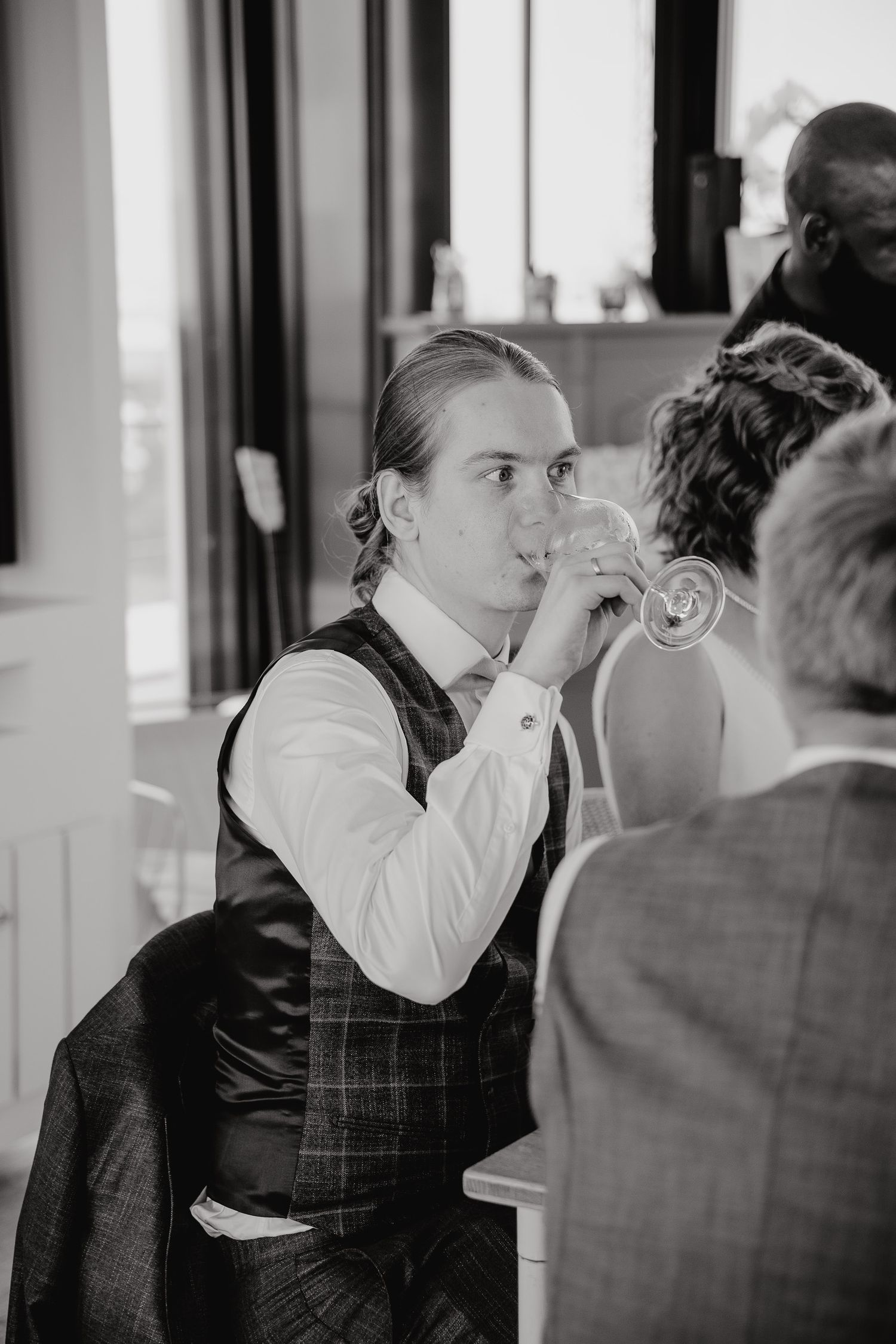 A sequence of black and white photos showing someone drinking from a glass in progressive stages.
