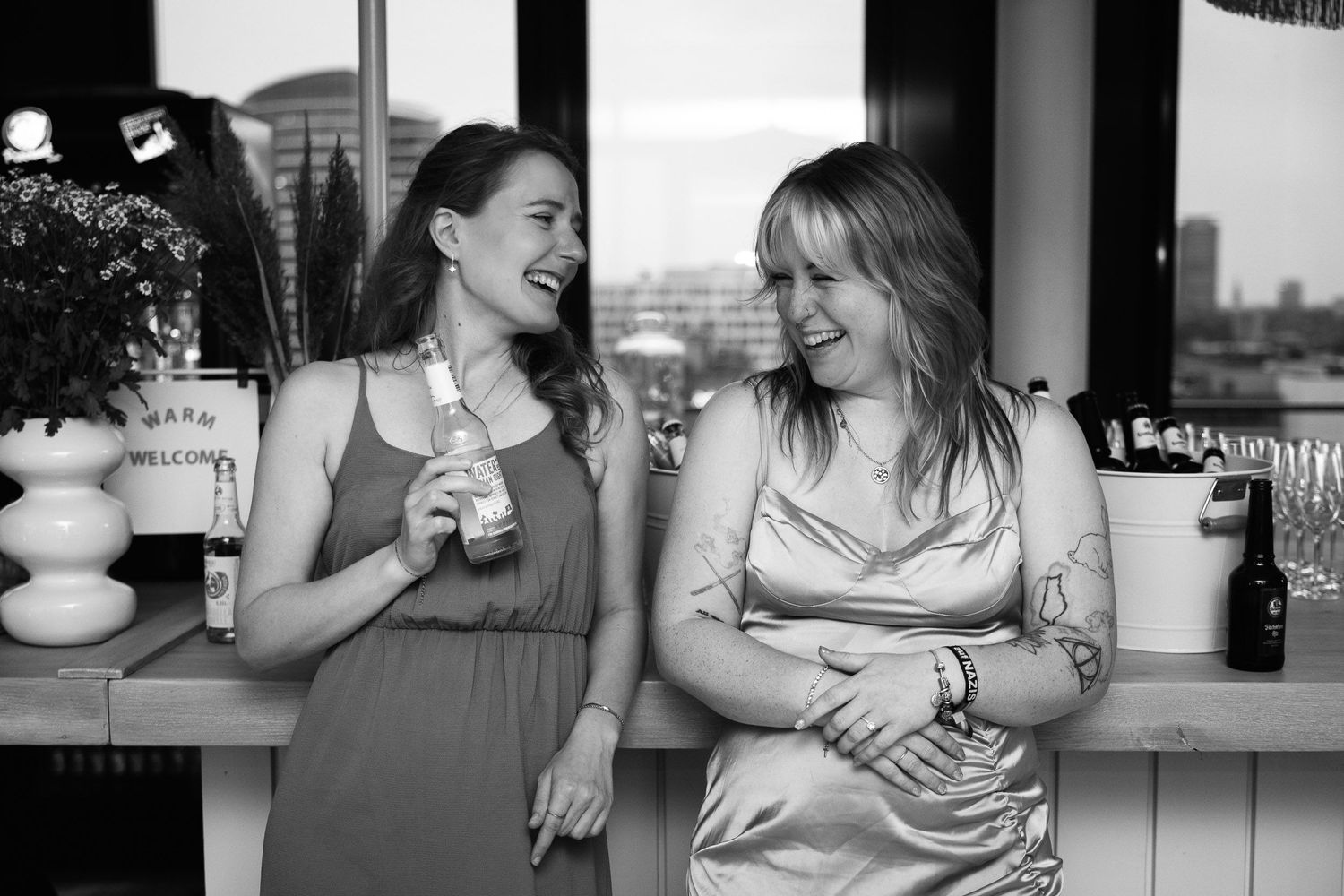 A series of candid black and white photographs showing tender moments between people in casual settings.