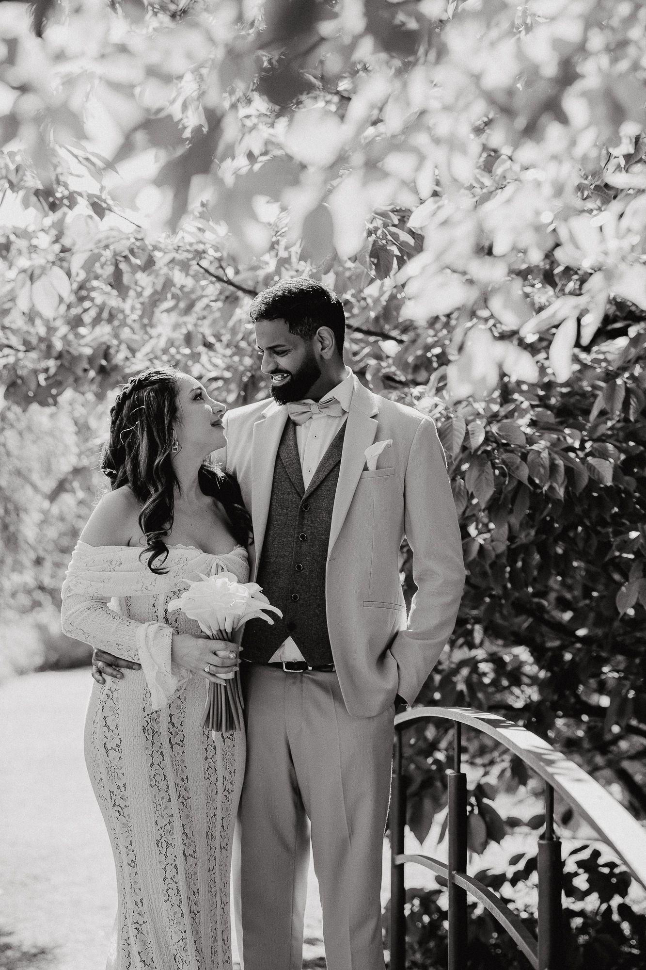 Black and white wedding portraits captured in dreamy outdoor setting.