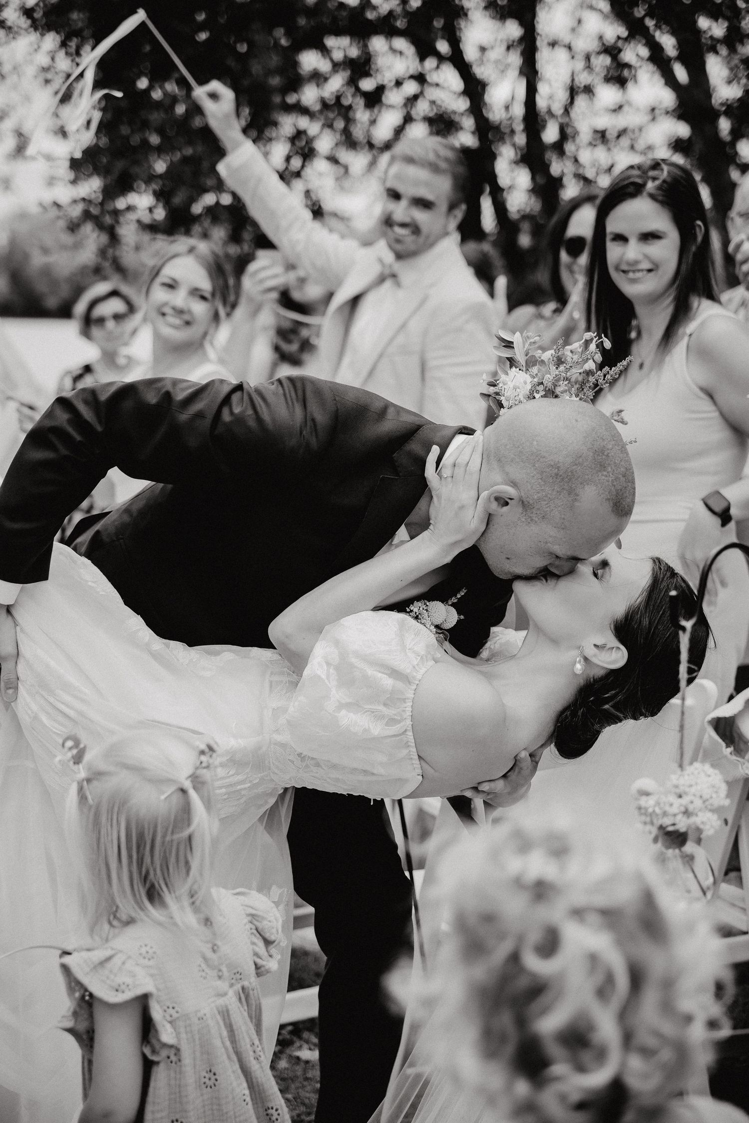 Wedding party dancing and celebrating in black and white on a joyous afternoon.