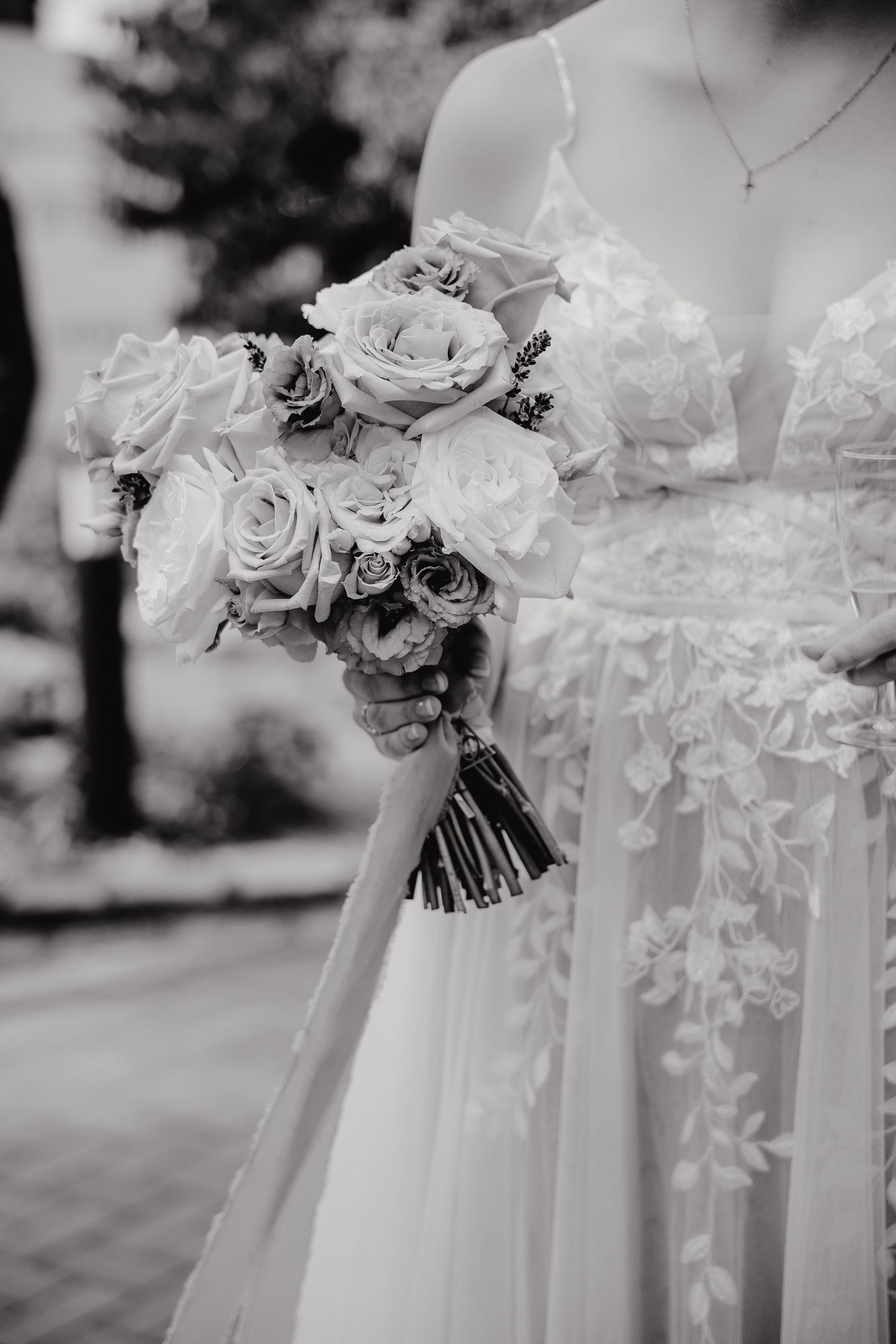 Black and white wedding photos showing delicate floral bouquets and flowing white fabric details.