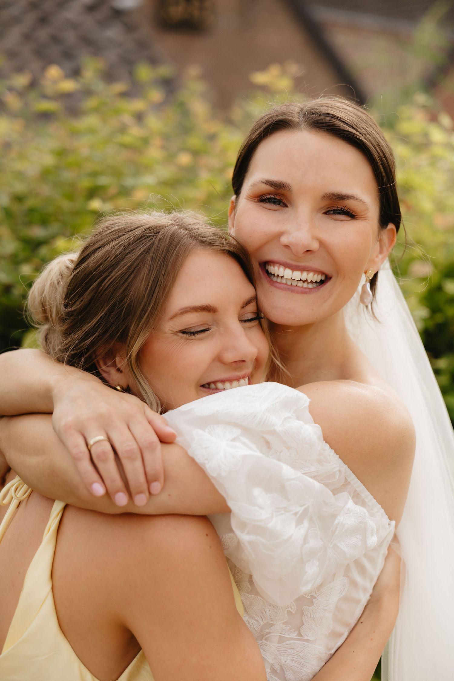 Close-up candid moment at an outdoor wedding celebration.