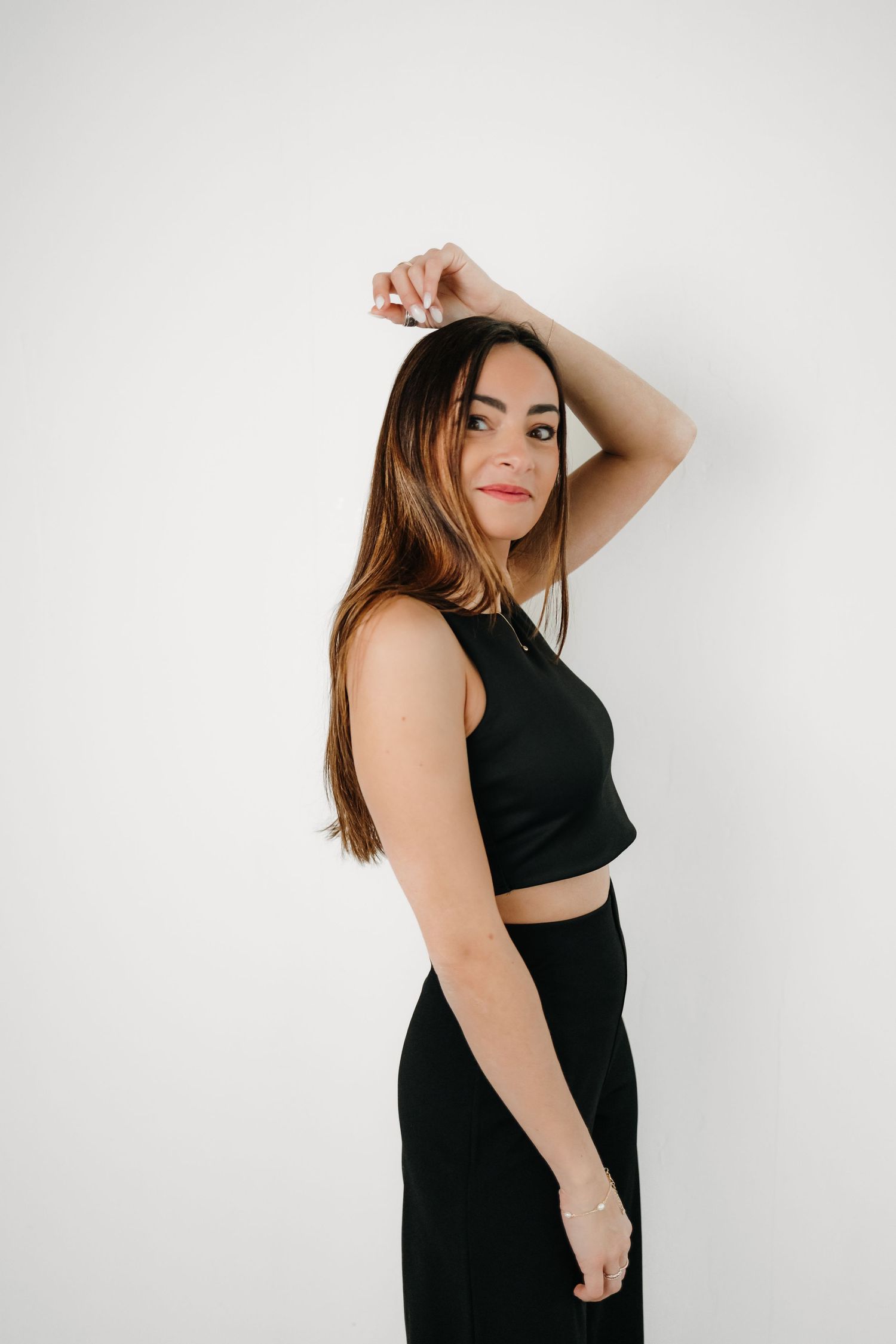 Artistic portrait series against white background featuring minimalist black outfit.