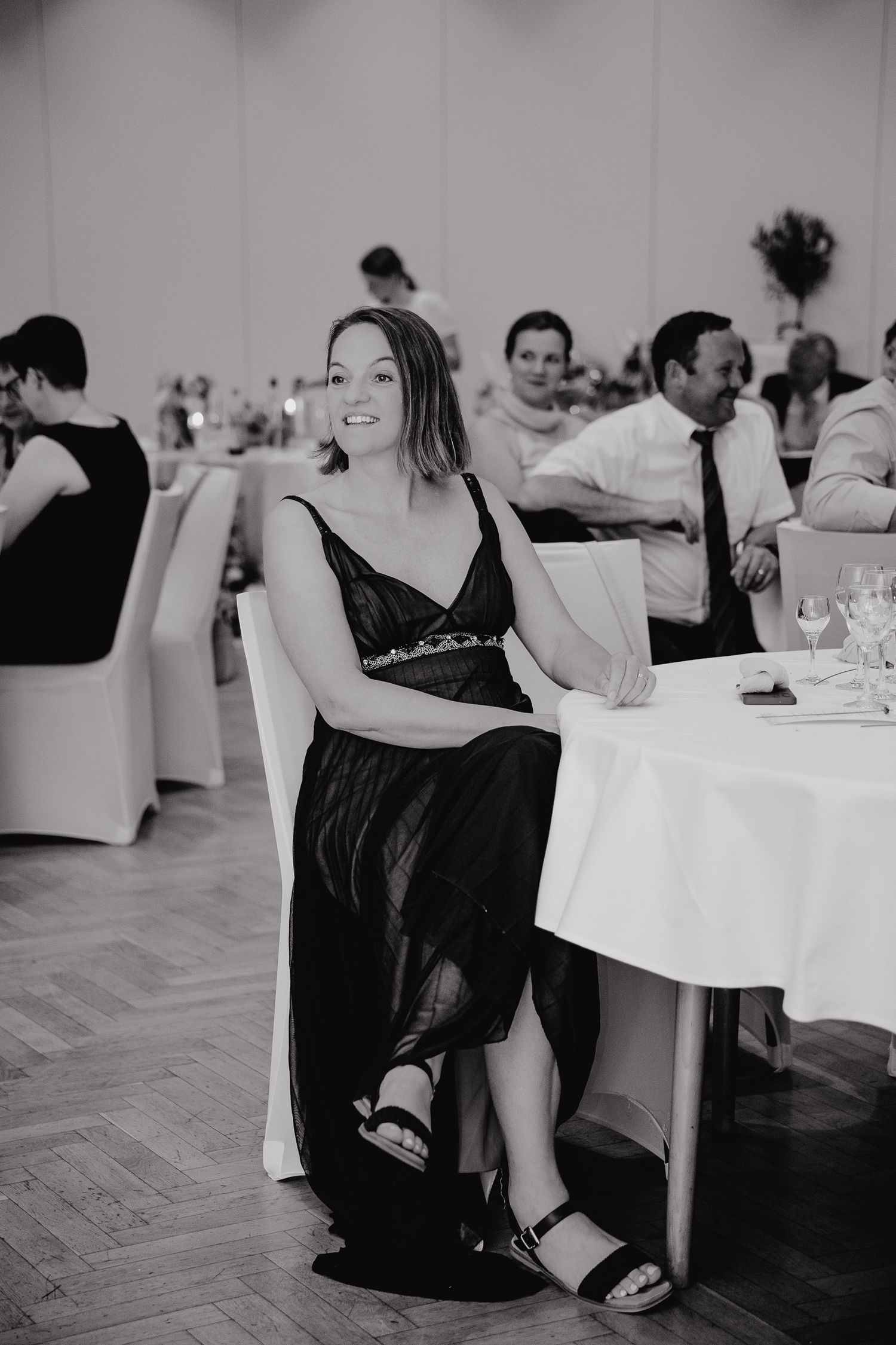 Black and white photo series of people sitting at tables during a formal dining event.