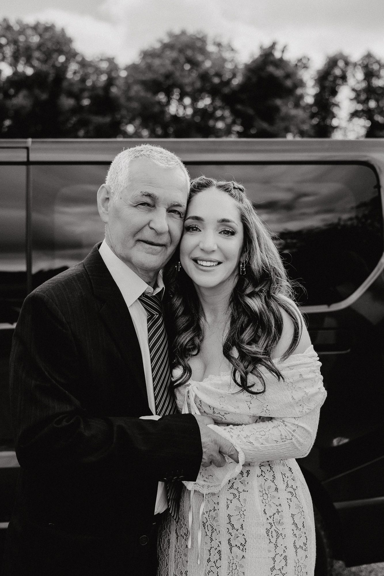 Black and white candid photos showing tender moments in formal attire.