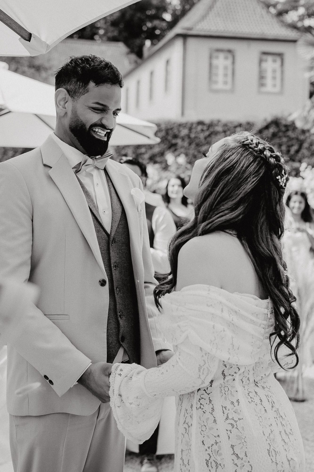 Black and white candid moments of newlyweds laughing during outdoor ceremony.