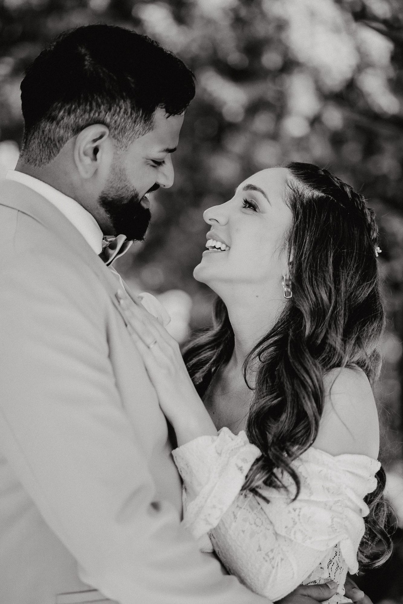 Black and white wedding portrait series showing tender moments between newlyweds.