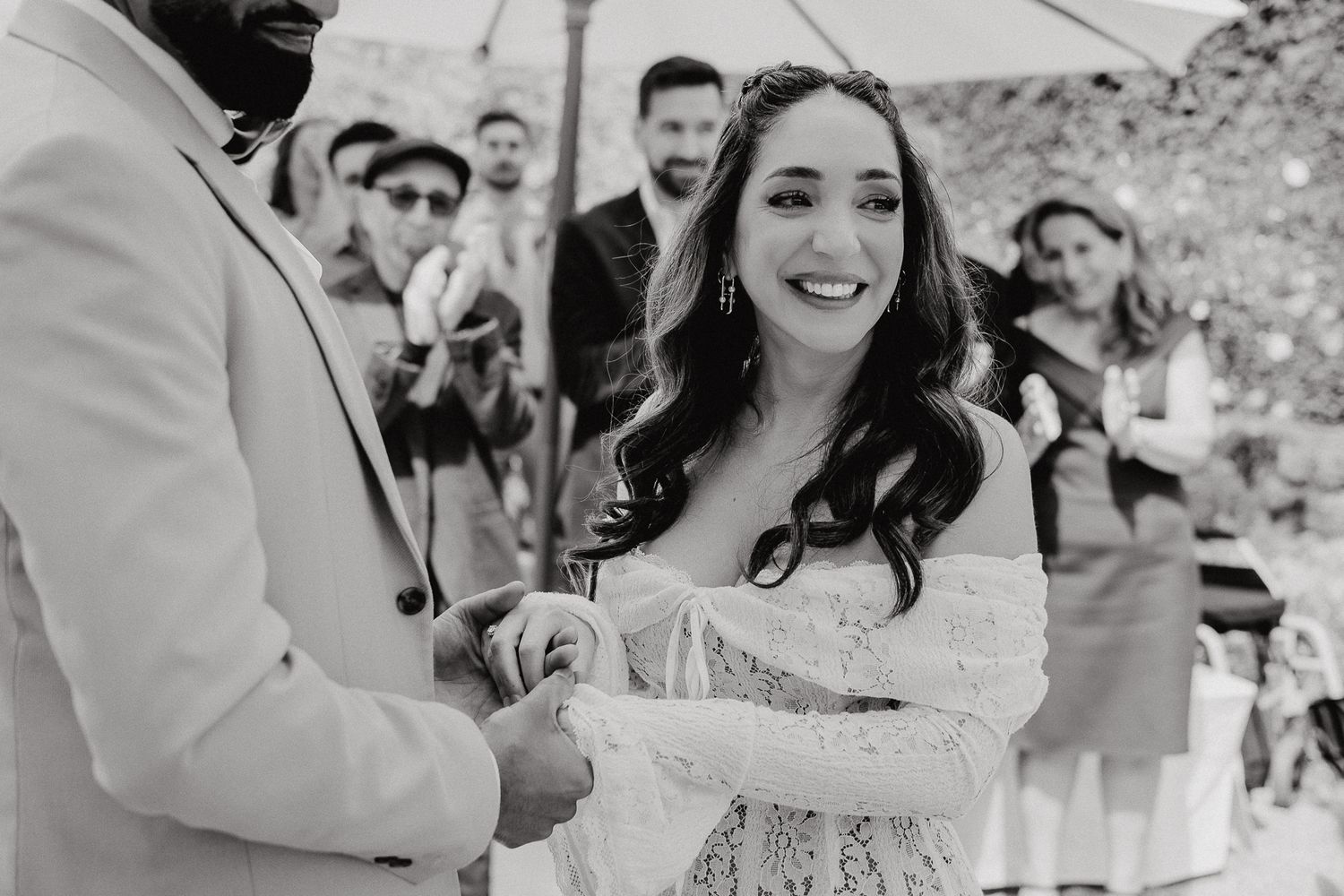 Candid moments of joy and laughter captured during outdoor wedding ceremony.