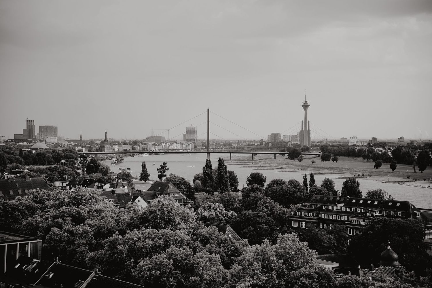 Historic black and white panoramic cityscape showing multiple views of a skyline with buildings and waterfront scenes.