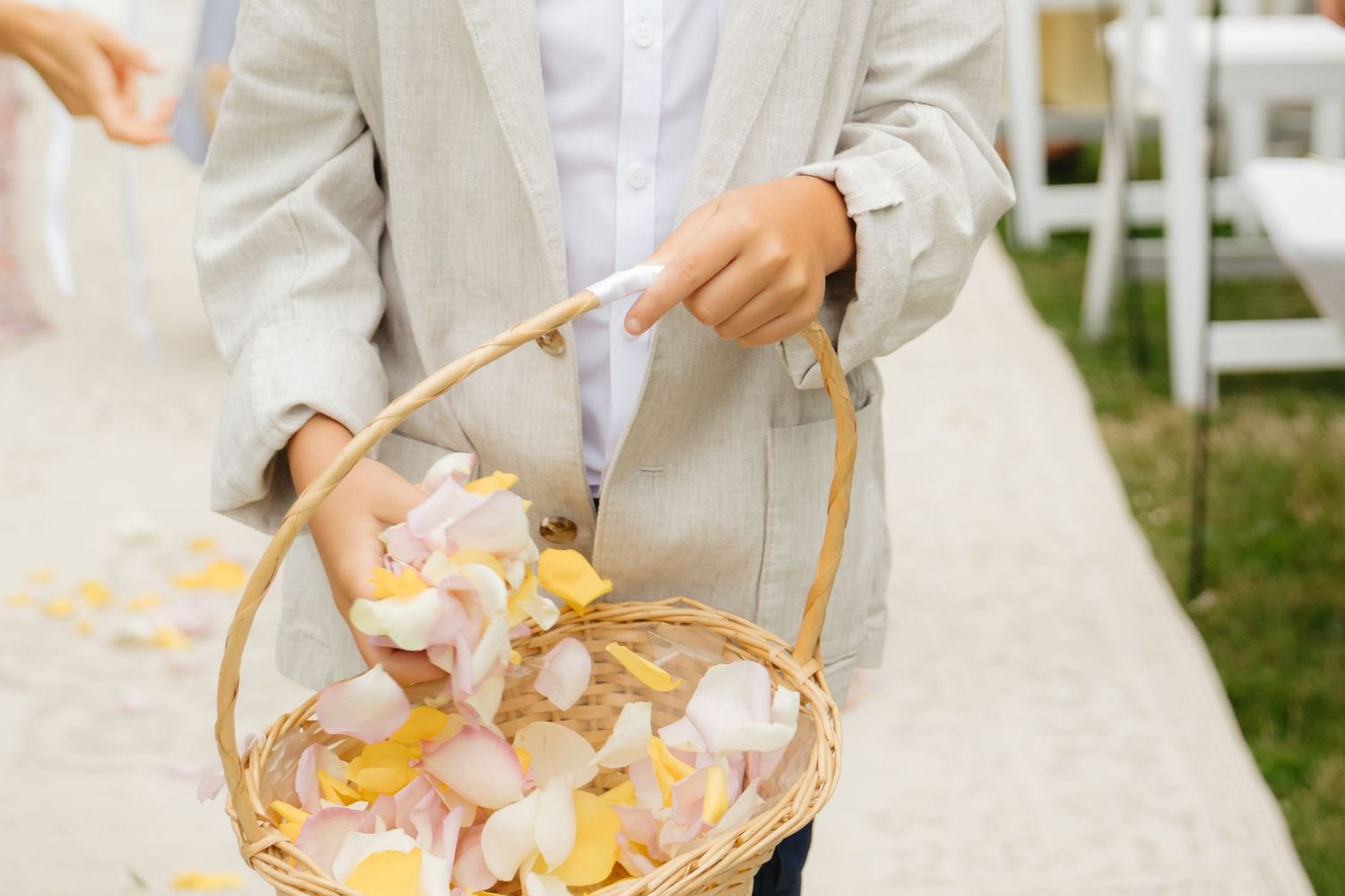 Wedding guests reaching for appetizers from a serving platter at an outdoor reception.