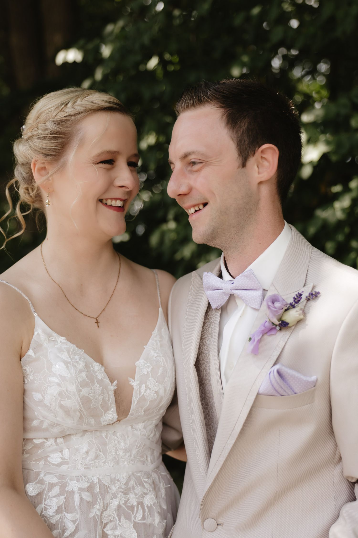 A series of romantic wedding photos showing a couple in white attire sharing intimate moments and laughter outdoors.
