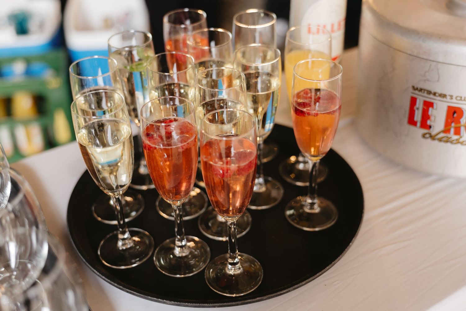 Elegant champagne glasses arranged on serving trays at wedding reception.